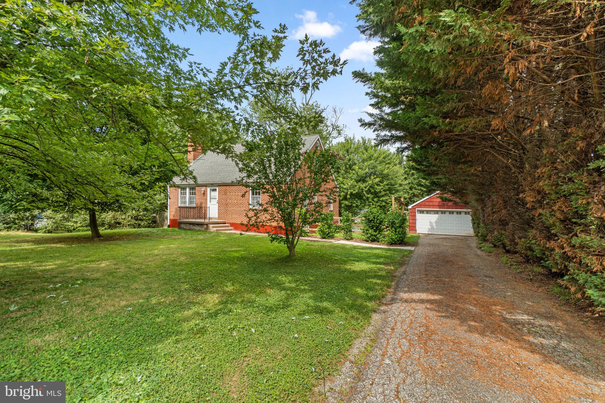 Welcome home to this charming brick Cape Cod nestled on a beautifully landscaped ¾-acre lot in one of Sykesville's most desirable locations. Offering 5 bedrooms, 2 full and 1 half baths, over 2,500 square feet of finished living space, and a detached 2-car garage, this home combines timeless character with thoughtful updates throughout.

Step inside to discover warm hardwood floors, inviting living spaces, and a beautifully updated kitchen featuring 42-inch cabinetry, wood countertops, stainless steel appliances, and an electric cooktop. The spacious living room is highlighted by a cozy wood-burning fireplace, while the adjoining sunroom provides the perfect place to enjoy your morning coffee or unwind while overlooking the spectacular backyard.

The flexible floor plan includes multiple bedrooms on the main and upper levels, with a finished lower level offering a large recreation room, additional bedroom or home office, half bath, abundant storage, and endless possibilities for guests, hobbies, or entertaining.

Outside is where this property truly shines. The private, fenced backyard offers mature landscaping, room to play, entertain, or garden, and creates a peaceful retreat that's difficult to find. Enjoy evenings on the deck, relax in the sunroom, or take in the beautiful sunsets from the welcoming front porch.

Major improvements provide peace of mind, including a new HVAC system (2025), new furnace (2025), hot water heater (2023), chimney relined (2025), radon mitigation system, and 200-amp electrical service.

Conveniently located just minutes from downtown Sykesville's shops, restaurants, parks, and commuter routes, this is the perfect blend of classic charm, modern updates, and everyday functionality.