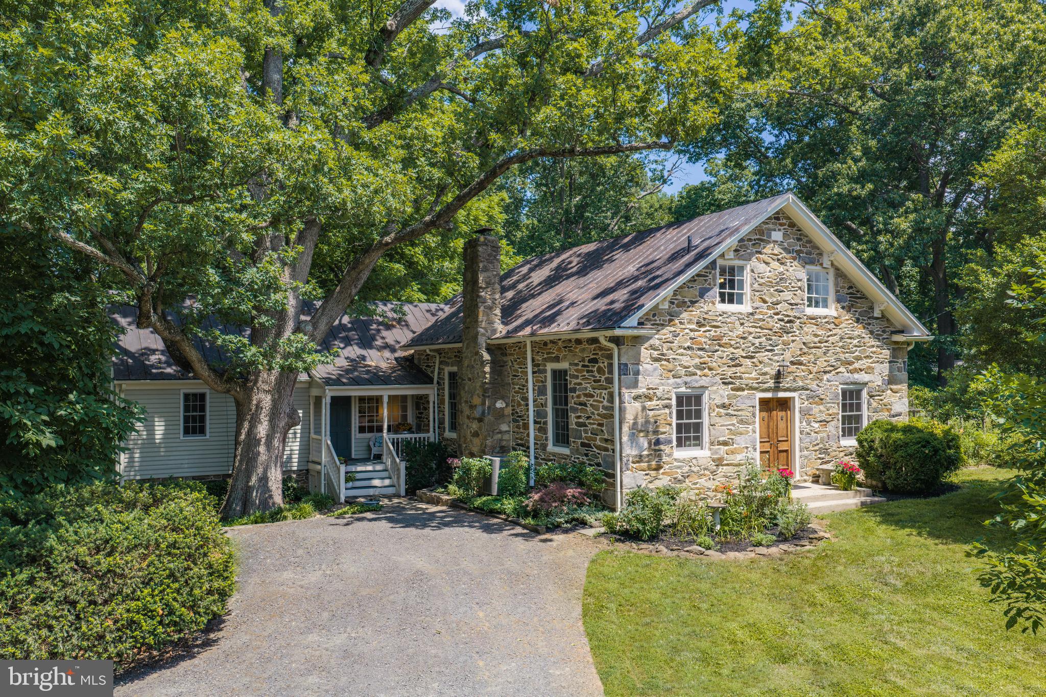 A VERY SPECIAL NEW OFFERING - Set on 3+ acres just outside the historic village of Hillsboro, established in 1752, this circa 1833 home began as the Salem Methodist Church and its detached schoolhouse. Both structures were built with local fieldstone walls 23 to 24 inches thick, and a late-1960s addition adds cypress siding. Today, the former church serves as a gracious entrance, with its original doors opening to a great room featuring vaulted ceilings and an expansive wood-burning fireplace. Artfully updated over the years, the home's 3,272 finished square feet still capture its true essence — from the stunning stone flooring in the former church to heart-of-pine and oak floors, black walnut fireplace mantels, and vintage wall sconces. The main house includes 3 bedrooms, 2 full baths, and 2 half baths, plus a 714-square-foot detached guest house. Historic charm and thoughtful updates come together seamlessly across both structures. The grounds are equally compelling, with a front porch, screened porch, expansive patio, manicured gardens, walking trails, and a barn for animals — all just off Route 9, amid the area's award-winning wineries, a short drive from downtown Purcellville.
