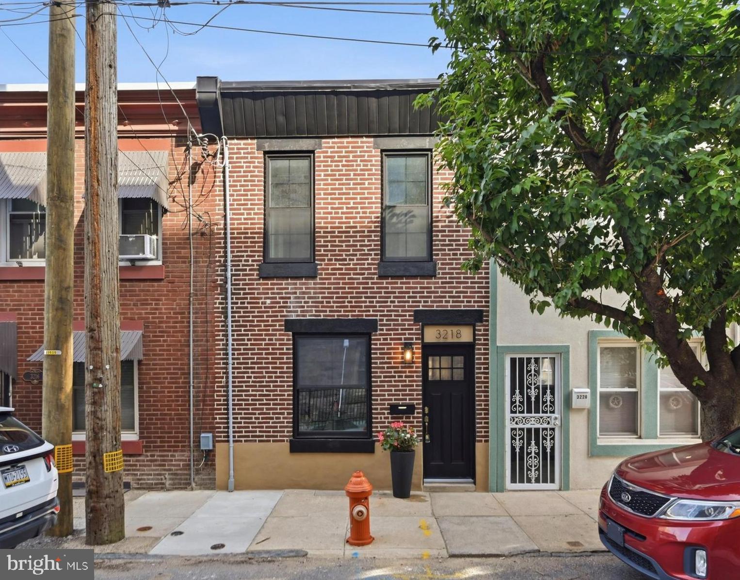Wait until you step inside this one. Nestled among the charming rowhomes of Port Richmond, 3218 Miller Street is a beautifully renovated gem where thoughtful design and quality craftsmanship shine throughout. Step inside this sun filled row and you'll immediately appreciate the custom touches that make this home stand apart, including newly installed bamboo floors, custom built ins with a fireplace, an original iron banister, exposed brick accents, and brand new black modern windows. The inviting layout flows seamlessly from the living and dining areas into the open kitchen, where a striking exposed brick wall adds warmth and character. Featuring white shaker cabinetry, quartz countertops, stainless steel appliances, and a full light glass door that fills the space with more natural sunlight where it seamlessly transition to outdoor living.

Just beyond the kitchen awaits your own private courtyard oasis. Newly installed stone pavers create a charming foundation for outdoor dining, morning coffee, gardening, or hosting intimate gatherings. Upstairs, you'll find two thoughtfully finished bedrooms and two beautifully updated full bathrooms, each designed with its own distinct style, from elegant gold accents and a stone shower floor to sleek black fixtures and contemporary finishes. One of the bedrooms features an exposed brick accent wall, adding even more character and charm. The partially finished basement also offers valuable flex space perfect for a home office, workout area, media room, or additional lounge space.

Additional upgrades include a new HVAC system with central air conditioning, an updated electrical panel, and quality improvements throughout. Ideally situated just steps from Campbell Square Park, Her Daughters cafe, La Roma, Miles Table, neighborhood delis, pizzerias, and local favorites. With easy access to public transportation, I 95, Allegheny Avenue, Fishtown, Northern Liberties, and Center City, this move in ready home offers the perfect blend of character, comfort, and convenience in the heart of Port Richmond.