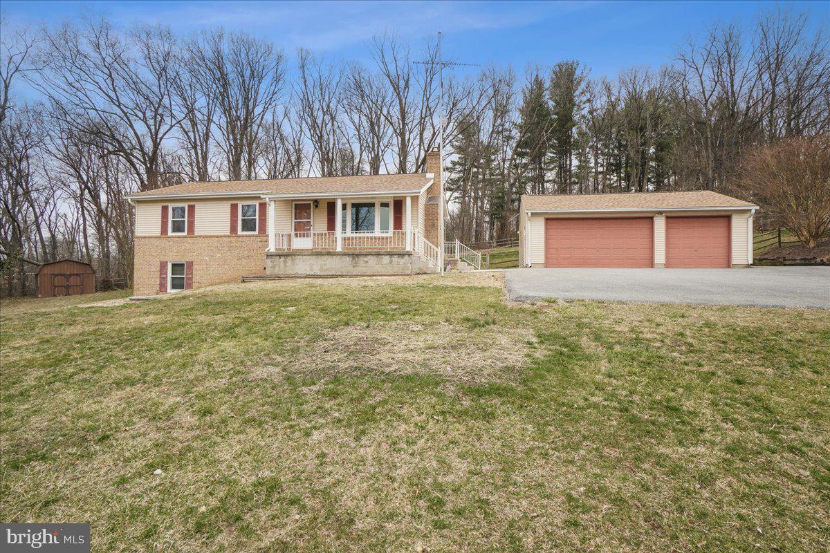 Pride of Providence! This Raised Rancher Nestled in a Coveted Cul-de-Sac Location on the Outskirts of Walkersville is Awaiting Your Finishing Touches! Freshly Painted with Neutral Colors, Newer Carpet and LVP Floor on the Main Level this Home Offers Three Bedrooms and Two Full Baths Upstairs, a Spacious Living Room with Floor to ceiling Cozy Fireplace, a Country Kitchen with Newer Stainless Appliances, and Connecting Dining Room with Large Table Space. Glass Doors Lead to Expansive Deck Overlooking Huge Fenced Backyard Perfect For Exploring or Entertaining! The Lower Level Is Boasting a Separate Living Area Perfect for In-laws or Au'Pairs, College Students or Just more Room To Spread Out- Work From Home/Virtual Learning. Large Second Family Room, Kitchen Area and a Bonus Room, Storage Area and Laundry Room, Plus a Full bath! Walk Out Glass Door to Side Yard Offers Warmth and Sunlight!
HUGE Detached Garage for the Hobbyist or Car Buff!  Lots of Parking at the Bottom and at the Top of the Driveway!  This GEM Won't Last Long!!