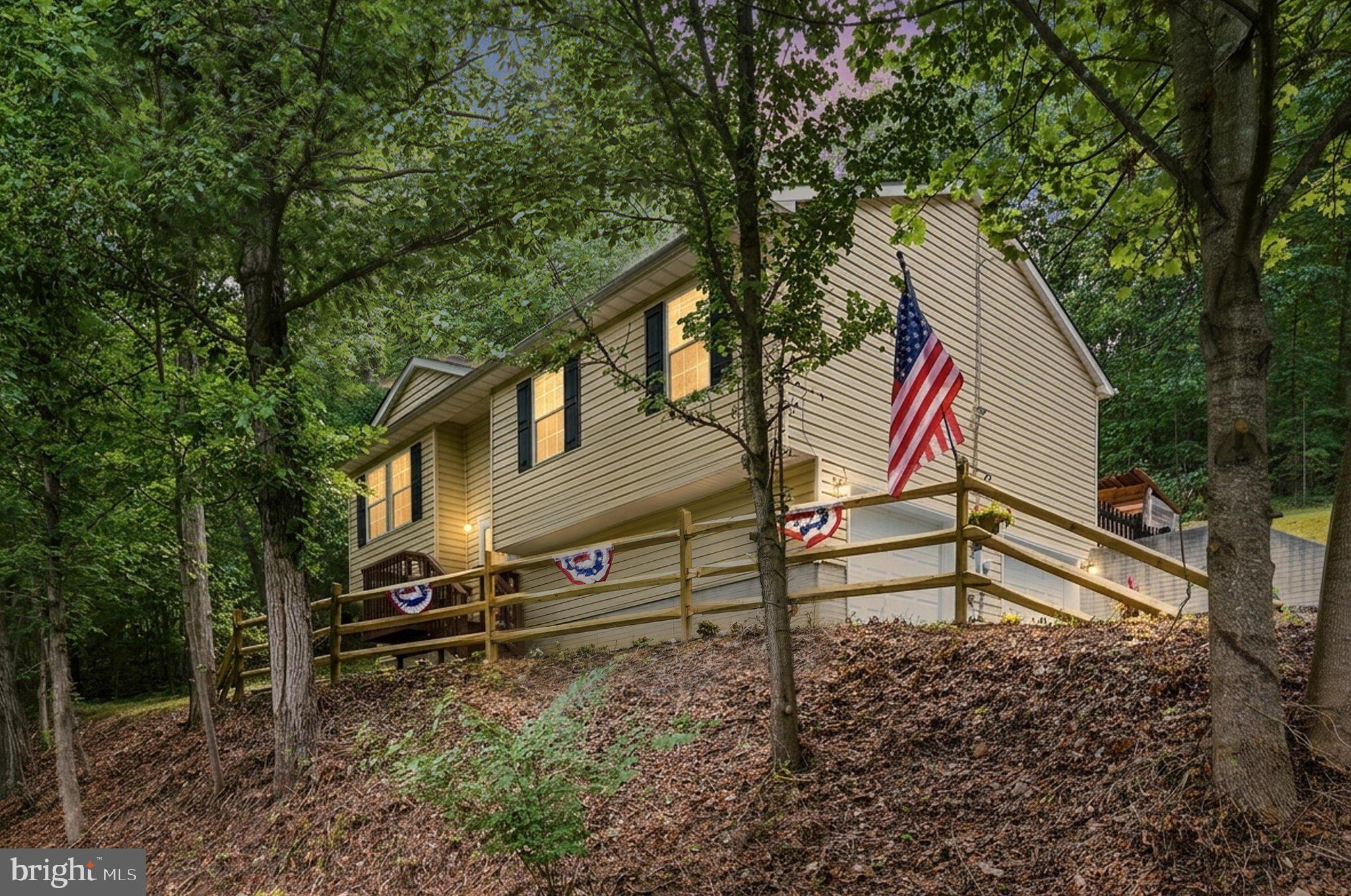 WOW! Beautifully renovated 3BR, 2BA home with 2-car garage in the Apple Mountain Lake community offers a move-in ready property with extensive interior and exterior updates/upgrades on 1+/- acre quiet lot with mature shade trees and lots of wildlife--deer, pileated woodpeckers, turkey, foxes and more! Recent (2026) improvements include new architectural shingle roof, LVP flooring, carpet, counter tops, sliding glass door, stainless appliances, remodeled bathrooms, finished lower-level living space and other recent (2023) improvements include new HVAC and septic pump. The main level features luxury vinyl plank throughout the spacious living room with fireplace, adjacent dining area leading to the deck, kitchen, as well as 3 carpeted bedrooms and 2 full baths. Fully-refinished lower level provides additional living space with potential for media room, work-out area, game room, guest room or office. Step outside onto the large refinished wood deck that leads to a fenced area with potting shed that creates a great place to relax, entertain and enjoy the peaceful rear yard and wooded surroundings.  The property has a private well with water conditioner and private septic. As a part of Apple Mountain Lake, residents/guests enjoy access to a private lake with sandy beach and swimming area, hard-surface basketball and tennis courts, tot lot, playground, all included with the low monthly HOA dues. The property is Xfinity high-speed internet connected and a Starlink verified location. Great commuter location just a few miles from Rte.55 and I-66 with no mountains to climb and on paved roads. Just minutes to the Shenandoah River, State/National Parks, wineries and local attractions. Truly a spectacular home so close to everything in a peaceful country setting. You Must Tour to Appreciate!!
