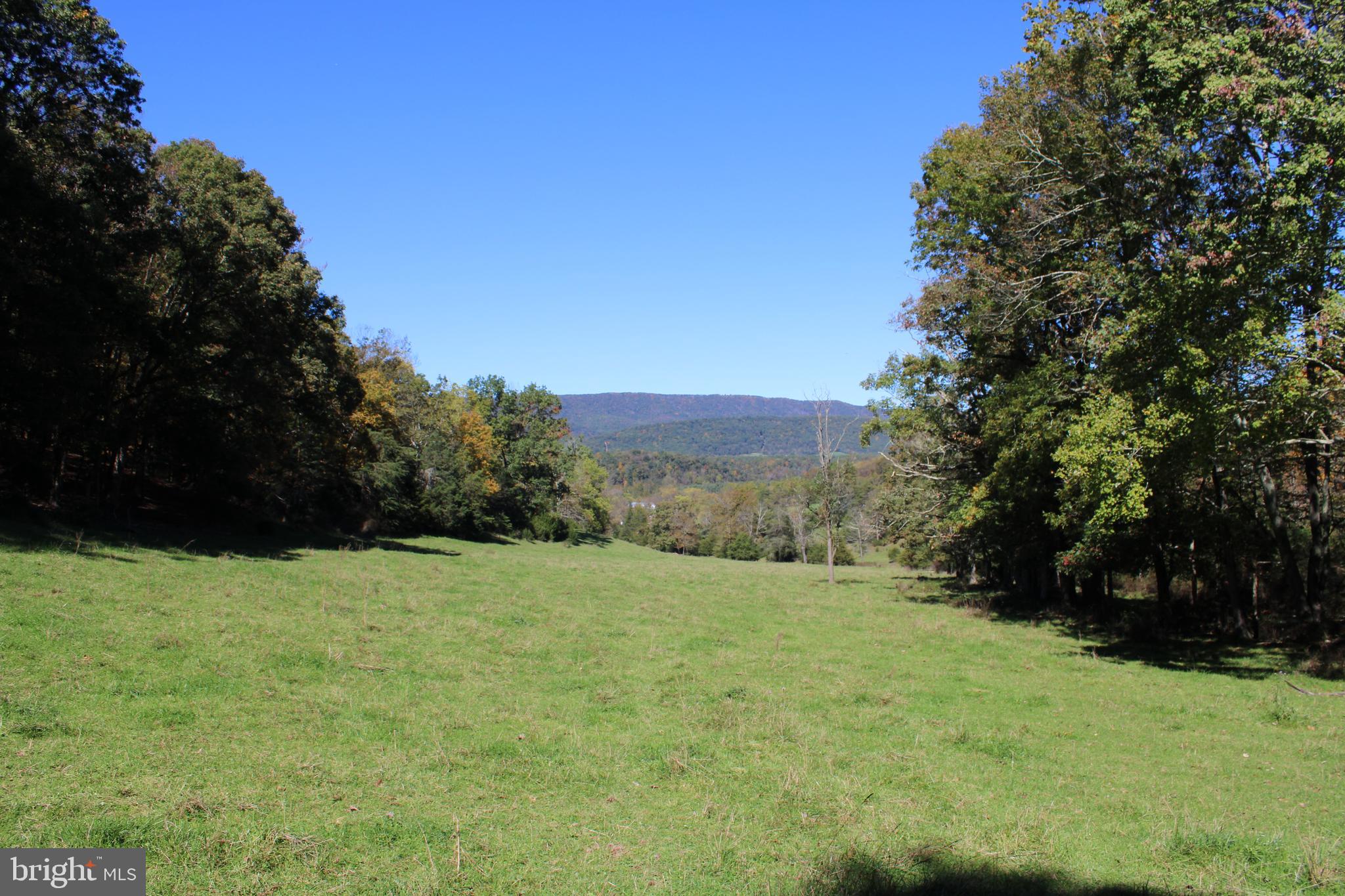 An extraordinary opportunity awaits in the heart of Hardy County, West Virginia, with this rare offering—33.03 acres of pure potential and natural beauty. This prime parcel combines breathtaking scenic views of the surrounding mountains and valleys with a perfect blend of towering hardwoods and open meadows, creating a truly captivating landscape. Whether you're looking to build your dream home, farm, or create the ultimate hunting retreat, this property has everything you need, offering you a blank unrestricted canvas. For the avid hunter, this land is pure paradise with unlimited and unrestricted potential. It’s crawling with wildlife, including deer, wild turkey, and the occasional bear sighting. There’s ample room to develop stand sites, and the great soil is perfect for food plots, making this a haven for game and offering endless hunting opportunities right on your own land. Natural springs and seasonal streams flow across the property, adding to its charm and appeal. A perimeter fence is already in place, making it well-suited for farming or livestock. Whether you're looking to hunt, farm, or simply enjoy the peace and quiet of your own piece of the Mountain State, this land offers endless possibilities. And while the property feels like a remote sanctuary, it’s located just a short two-hour drive from the Washington/Baltimore Metro area, with easy access to the George Washington National Forest for even more outdoor adventures. This unique offering combines natural beauty, recreational potential, and convenience—all in one stunning package. The only limit here is your imagination.