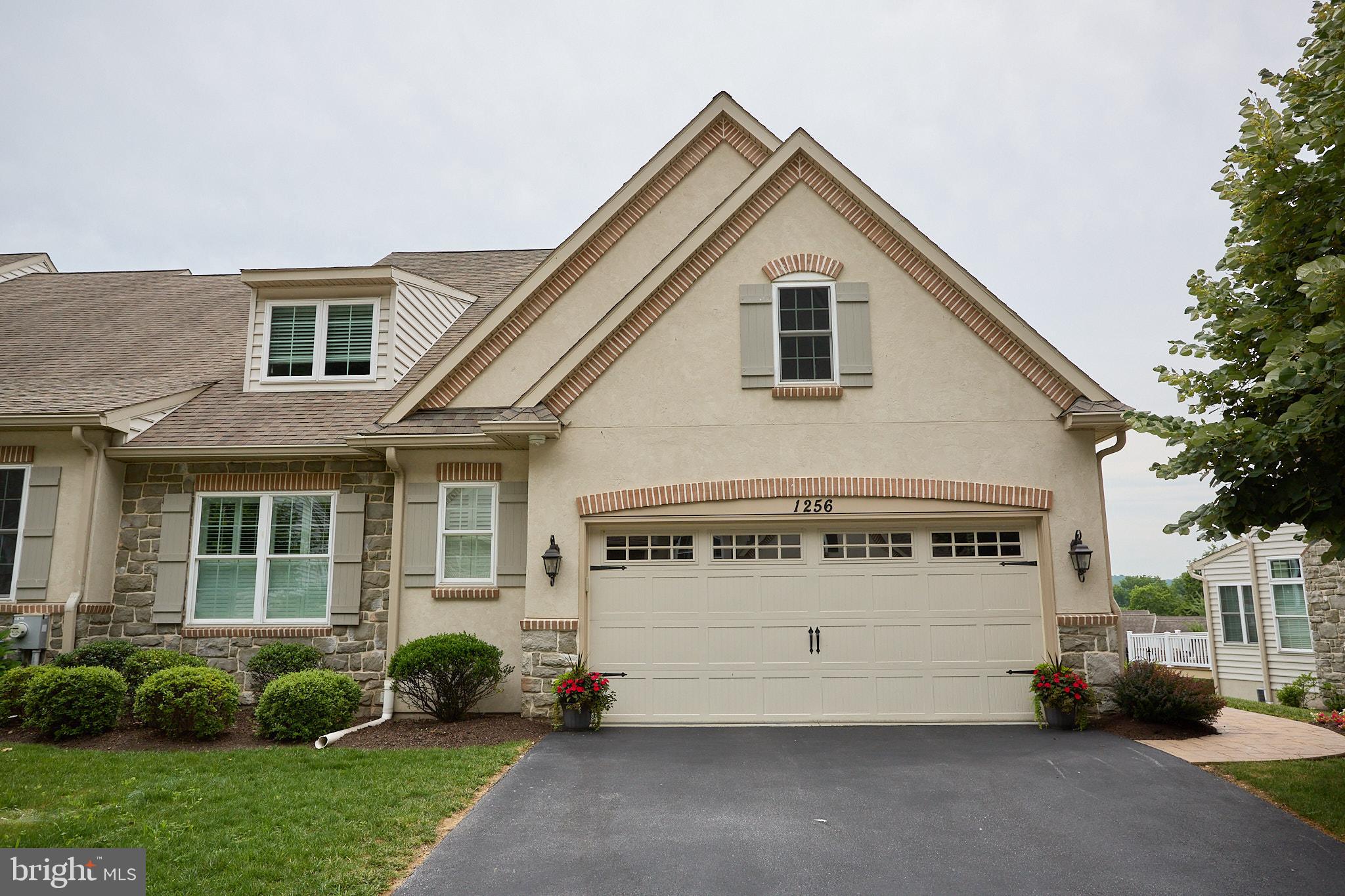 Arguably offering the best view in the community, this stunning end-unit carriage home combines luxury upgrades, thoughtful design, and the ease of low-maintenance living in one of Downingtown's most desirable 55+ neighborhoods.
The heart of the home is the fully customized kitchen, redesigned from start to finish with both beauty and functionality in mind. Features include GE Profile appliances, a Bosch dishwasher, custom cabinetry, a convenient small appliance garage, and abundant workspace for everyday living and entertaining.
The open floor plan is anchored by a dramatic two-story family room featuring a cozy gas fireplace and soaring ceilings. This lovely space connects seamlessly to the kitchen and dining area which are accented by hardwood flooring. Just beyond, a sun-drenched morning room provides the perfect spot to enjoy your morning coffee while taking in peaceful views through sliding doors to the private composite deck.
The first-floor primary suite offers the convenience of main-level living and features a spacious walk-in closet and en-suite bath with a walk-in glass shower. A laundry room, powder room, and attached two-car garage complete the main level.
Upstairs, you'll find two generously sized bedrooms connected by a Jack-and-Jill bath with a dual-sink vanity and glass-enclosed shower. A versatile loft overlooking the family room below provides additional living space perfect for a home office, reading nook, or guest retreat.
The unfinished walkout basement provides incredible potential for future expansion and is a standout feature of the home. Complete with double glass doors and a full-size window, this bright lower level offers direct outdoor access and endless possibilities for additional living space, a home gym, recreation room, workshop, or abundant storage.
Additional highlights include custom window treatments throughout much of the home, including plantation shutters in the family room and primary suite.
Ideally located near shopping, dining, parks, golf, major routes, and everyday conveniences, this exceptional home offers the perfect blend of elegance, comfort, and carefree living.
Taxes Are in process of being appealed.
