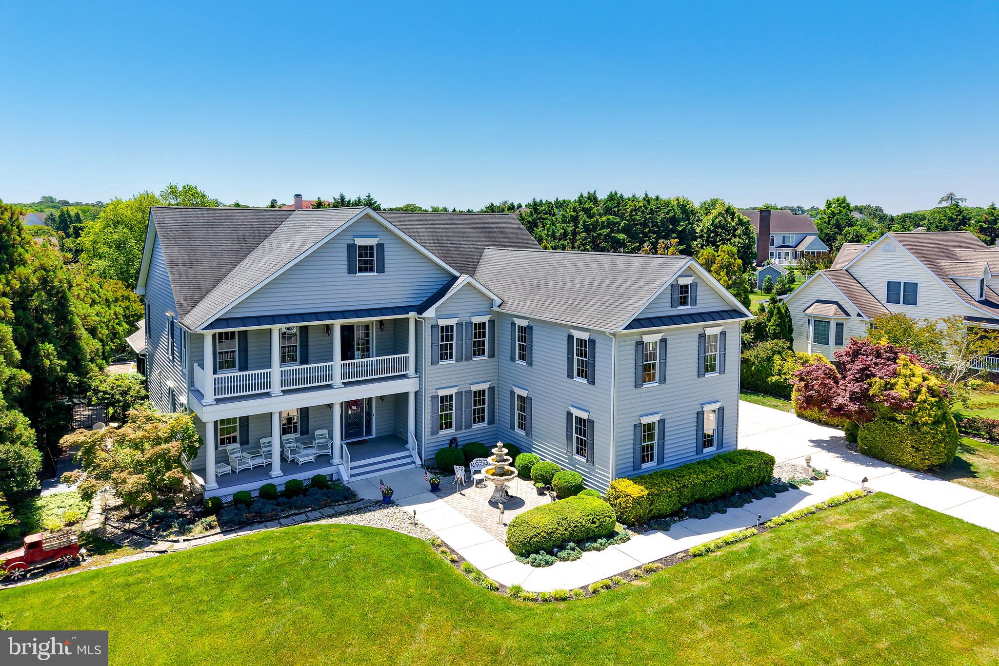 YOUR PERSONAL LEWES RESORT 

Just minutes from downtown Lewes and the beach, yet tucked away in complete privacy, this extraordinary estate delivers a true resort-at-home lifestyle. Set on a beautifully landscaped, tree-lined property, this exceptional residence offers more than 5,500 square feet of heated living space combining luxury, comfort, and endless entertainment opportunities.

A stunning courtyard fountain, covered double front porch, and grand foyer create an unforgettable first impression. Inside, rich hardwood flooring, exquisite crown moldings, and a dramatic two-story great room with a coffered ceiling and gas fireplace establish an elegant yet inviting atmosphere throughout the home.

Designed for both everyday living and grand-scale entertaining, the main level includes a private executive office, formal dining room, and an exceptional gourmet kitchen. The kitchen is a chef’s dream, featuring premium granite countertops, dual islands, extensive tongue-and-groove cabinetry, Sub-Zero refrigerator, Wolf cooktop with warming drawer, Thermador double wall ovens, and Bosch dishwasher.

The luxurious first-floor owner’s suite serves as a private retreat, complete with a custom mantel gas fireplace, direct deck access, an expansive walk-in closet with custom built-ins, and a spa-inspired bath with jetted soaking tub and custom-tiled shower.

Upstairs, guests and family will enjoy an incredible entertainment level featuring a private theater room with included media seating, a spacious billiards and game room with custom wet bar, an adjoining family room, four generously sized guest bedrooms, two full baths, and access to the charming second-story front porch.

Step outside and discover a backyard oasis that rivals a five-star luxury resort. Spend summer days relaxing in the private saltwater pool, soaking in the hot tub, or entertaining from the fully covered outdoor kitchen. As the sun sets, gather around the impressive stone wood-burning fireplace on the expansive paver patio or enjoy a friendly match on your private bocce ball court. Additional outdoor amenities include a dining pergola with lighting, lush professional landscaping, custom walkways, a covered deck, screened porch with ceiling fan, and a large custom storage shed.

Car collectors, boating enthusiasts, and hobbyists will appreciate the property’s remarkable garage capacity. A rare combination of an attached three-car side-entry garage and attached two-car front-entry garage provides abundant space for vehicles, watercraft, beach equipment, storage, or workshop space.

Ideally located just moments from the Lewes-Rehoboth Canal, Lewes Beach, scenic bike trails, boutique shopping, and acclaimed restaurants, this property offers the very best of coastal Delaware living.

Adding even more value, this remarkable estate is offered below its recent appraised value, presenting a rare opportunity for immediate equity and an unmatched luxury lifestyle in one of Lewes’ most desirable locations.