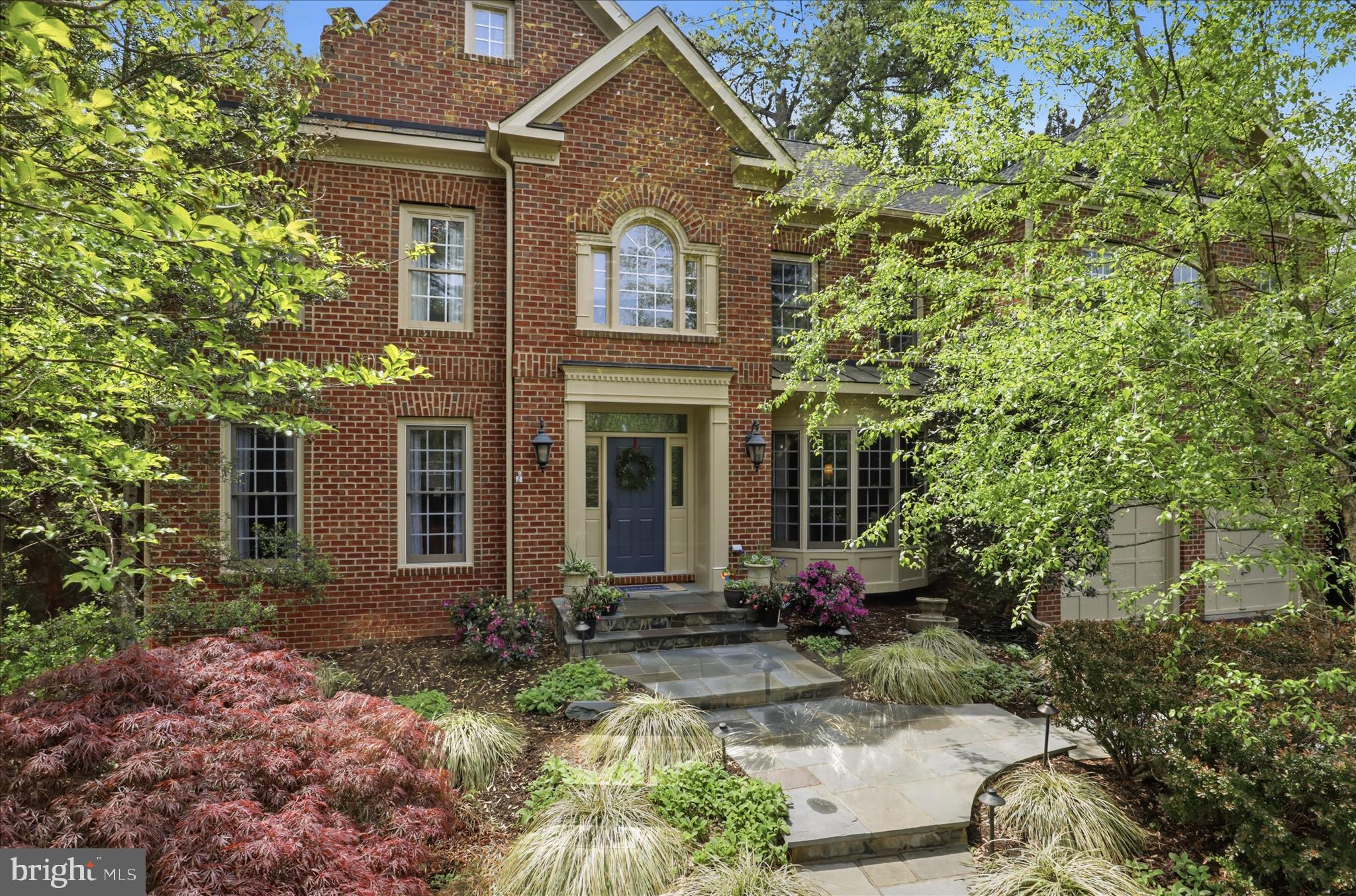 Offers Request by Monday, May 4th at 2pm. Welcome to this expansive all-brick colonial in the highly regarded Langley Farms neighborhood, offering timeless architecture paired with thoughtful, modern updates. Rich in detail, the home features extensive moldings, hardwood floors, 9-foot ceilings, three fireplaces, and serene views of the beautifully landscaped grounds from nearly every room. 
A welcoming foyer introduces light walnut-toned oak floors that flow seamlessly throughout the main level. The private home office, complete with a bay window, overlooks the front yard, while the formal living and dining rooms provide elegant yet comfortable spaces for both everyday living and special gatherings. 
At the heart of the home, the fully renovated kitchen is designed for both function and style. Highlights include a large center island, custom cabinetry, a Thermador refrigerator, wine cooler and freezer, gas cooktop, double ovens, built-in microwave, and an expansive breakfast bar that opens to a light-filled sunroom. The adjoining family room impresses with walls of windows and a striking stone gas fireplace. 
Upstairs, the luxurious primary suite offers a peaceful retreat with cathedral and vaulted ceilings, a sitting area, and a spa-inspired bath featuring a soaking tub for two and a glass-enclosed shower with dual shower heads. The suite is complemented by two walk-in closets, a dressing area with vanity, and a linen closet. Three additional spacious bedrooms, each with walk-in closets, complete this level.
The bright, walk-out lower level provides exceptional versatility, featuring a large recreation room with a stacked stone gas fireplace and an impressive wet bar with glass display cabinetry and a stainless steel refrigerator—ideal for entertaining. A generously sized guest suite with a walk-in closet adds comfort and privacy.
Outdoors, the professionally landscaped grounds create a private retreat designed for year-round enjoyment. A substantial stone patio with a built-in grill and firepit anchors the space, complemented by a tranquil water feature, natural boulders, and a charming bridge over a gently flowing creek. Mature trees and lush plantings enhance the sense of privacy, while a sprinkler system and extensive landscape lighting add convenience and ambiance. The lush grassy yard can accommodate a pool. 
Ideally located just two blocks from the highly rated Langley High School and two blocks to Clemyjontri Park, this exceptional home also offers easy access to major commuting routes, shopping, dining and everything in the DC Metro area.