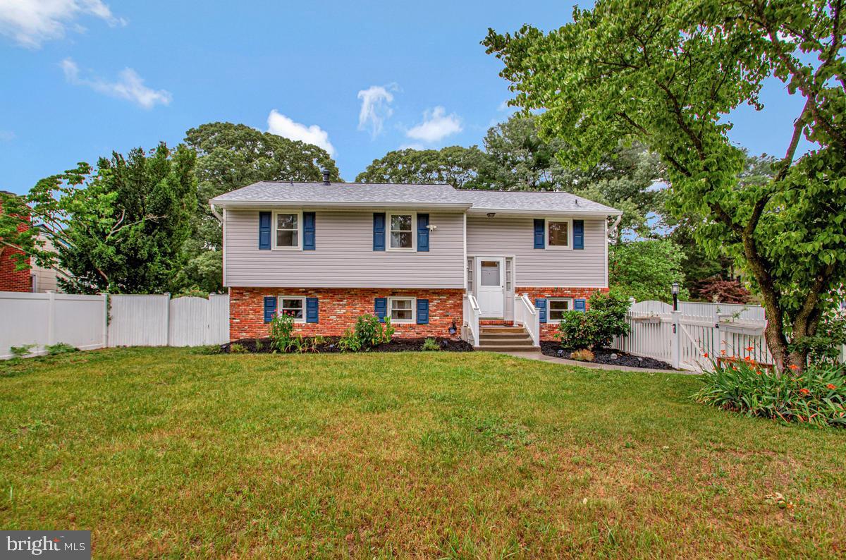 Nestled on an expansive lot in the sought-after water-privileged community of Magothy Manor on the Broadneck Peninsula, this charming 4-bedroom, 2 full bath home offers the perfect blend of comfort, space, and convenience. The bright kitchen is beautifully updated with granite countertops and stainless-steel appliances, creating an ideal space for everyday living and entertaining. Refinished hardwood floors add warmth and character throughout the main level where you'll find a welcoming living room highlighted by a cozy wood-burning fireplace and a separate dining room perfect for gatherings. Spacious bedrooms provide a place to retreat. The finished lower level features a large family room with a second wood-burning fireplace, an additional bedroom, and a full bath. Enjoy outdoor living from the screened porch overlooking the fenced backyard. Both front and rear yards are fenced and offer privacy and room to play. The oversized side-entry garage in the fenced rear yard provides exceptional space for car collectors, hobbyists, or storage. A new roof adds value and peace of mind. Residents enjoy access to community amenities including a beach, playground, and picnic area on the Magothy River when joining the voluntary community association, making this home an outstanding opportunity to enjoy the Chesapeake lifestyle.