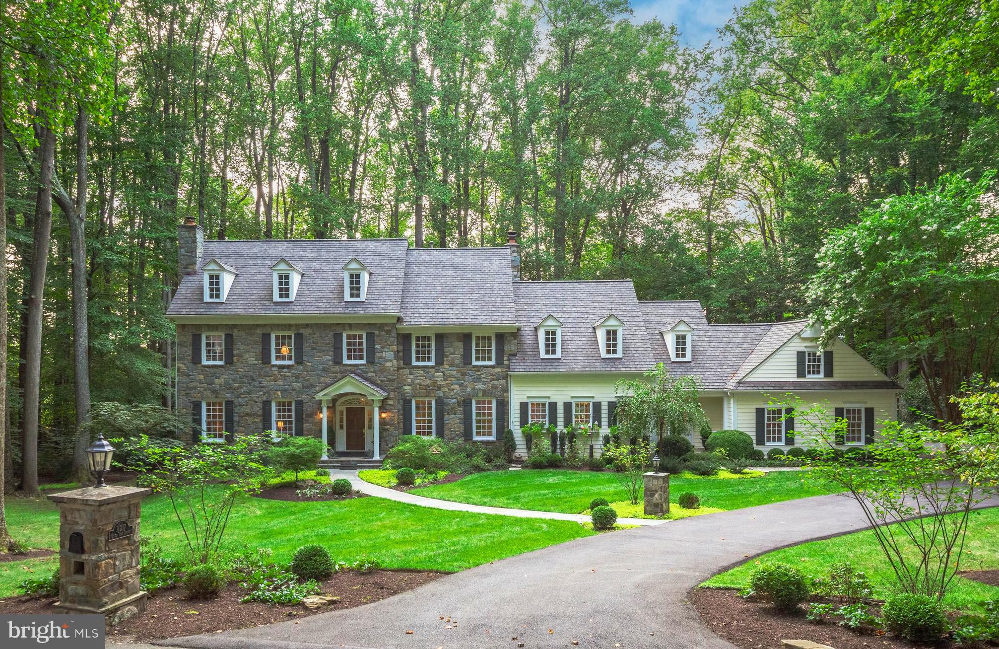 This exquisite 6-bedroom, 5.5-bathroom home is a true gem, offering over 7,000 square feet of luxurious living on a meticulously landscaped 1.47-acre lot in the prestigious Marwood community. Crafted by Visnic Builders, every detail of this residence exudes elegance and sophistication.

As you approach, the grand wood front door, framed by intricate stonework, sets the stage for the beauty within. Step into the foyer, where a stunning wood staircase greets you, and discover a home filled with custom features and thoughtful design. The main level showcases rich hardwood floors, a beautifully appointed office with custom built-ins, and a great room centered around a striking stone fireplace. The heart of the home is the kitchen, featuring brand-new countertops, an expansive island with a breakfast bar, and ample space for cooking, dining, and gathering. Adjacent to the kitchen is a charming breakfast room, complete with a cozy stone fireplace and sliding doors that lead to the private flagstone patio and porch. A main level powder room, mudroom with a full bath, laundry, and walk-in pantry add convenience to the home. From the mudroom, you also have easy access to the oversized side-loading 3-car garage.

Ascend the breathtaking staircase to the upper level, where a majestic window captures your attention. The primary suite is a true retreat, offering two spacious walk-in closets and a luxurious en suite bathroom with a Jacuzzi tub and separate shower. This level also includes a lovely reading nook/social lounge area, four additional secondary bedrooms, two additional bathrooms, and a well-appointed laundry room with ample storage.

The walkout lower level is a haven of relaxation and entertainment, featuring a newly constructed bedroom suite with an en-suite bathroom, dressing area, and an expansive walk-in closet with access to a covered patio and the private backyard. The lower level also includes a great room, a recreation/game room, a gym with mirrored walls, and extensive storage with an additional washer and dryer. Just beyond the serene backyard, a newly created walking path leads to the river, offering a peaceful retreat.

Recent updates include an oversized parking pad, a new roof, and widened stone walkways. Special features of the home include five gas fireplaces, an underground sprinkler system, an invisible fence, central vac, two hot water heaters, a newer HVAC system, a main-level full bath, a cedar closet, laundry on all three levels, a rough-in elevator shaft, and expansive porches and patios that extend gracefully across the treelined backyard.   

This home is a true masterpiece, boasting spectacular curb appeal and exquisite craftsmanship, offering a resort-like setting just minutes from the shops and restaurants of Potomac Village.  Don't miss out on this rare opportunity to own a home in the prestigious Marwood community!  Enjoy a leisurely walk down tree-lined streets, play fetch with your dog, or kick a soccer ball in the neighborhood's open field.