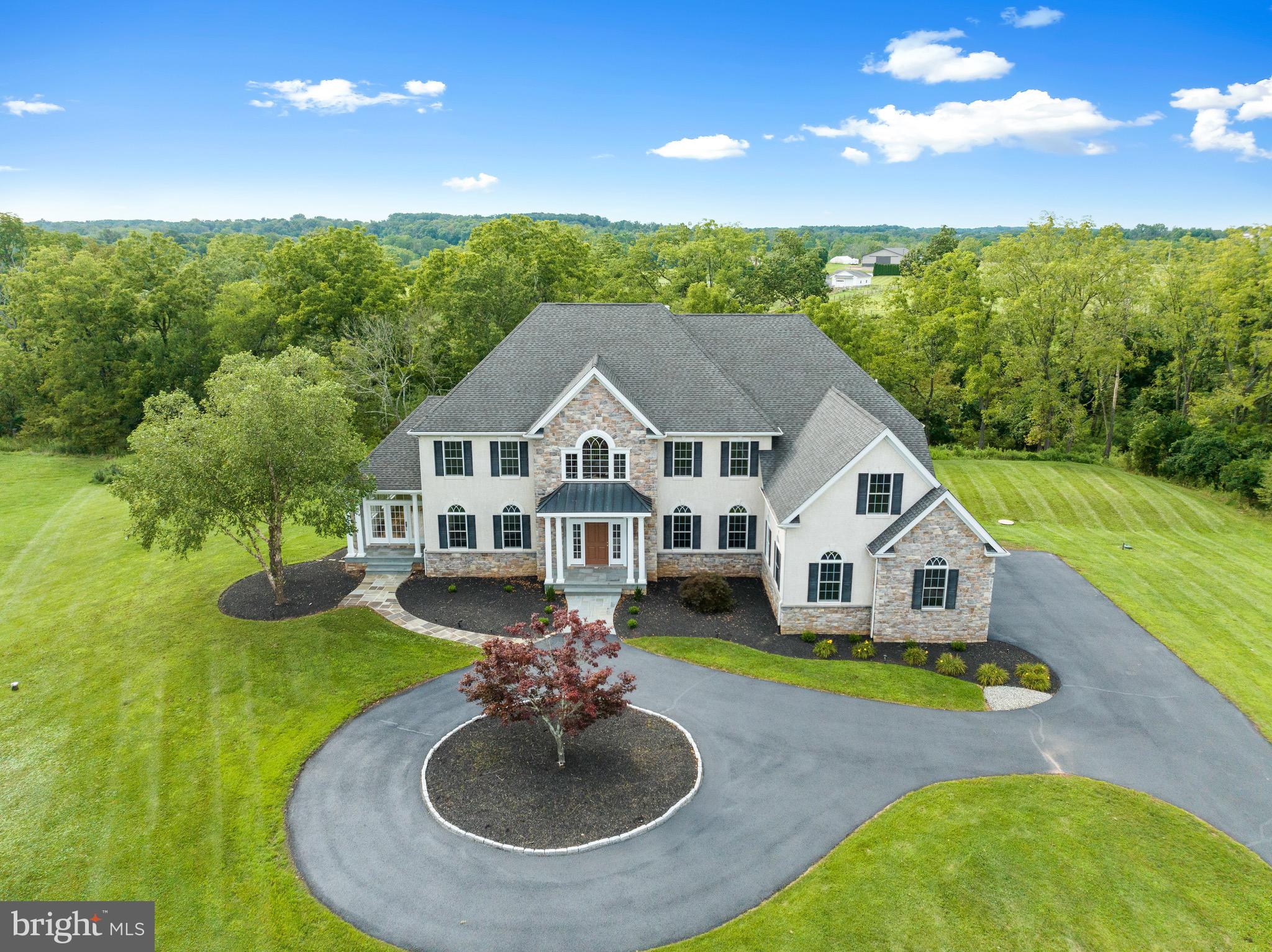 Welcome to 80 Alexandrea Circle!  This stunning, custom built home is nestled in a cul-de-sac on 2.2 spectacular acres in Alexandrea Estates located in Lower Salford Township.  This extremely, well maintained home features a three-car garage, four bedrooms, three full baths, one powder room and two additional rooms that can be used as an office, playroom, gym or extra bedroom! You will be taken in by the beautiful landscaping with circular driveway, the curb appeal is abundant. Step inside to discover the grand foyer with dual stairs, 9-foot-tall ceilings and the abundance of natural light streaming in through the oversized windows. As you explore the main level, you'll be captivated by the generous two-story family room, coffered ceiling, complete with a focal propane fireplace. This home is an entertainers paradise with the breathtaking, sun drenched, large sunroom with wet-bar, gorgeous hardwood flooring and crown molding. Gathering family and friends over for holiday dinners in the formal dining room, which seamlessly flows into the magnificent, striking kitchen. Here you will find granite countertops, stone/tile backsplash, large center island, two dishwashers, a gourmet stove/oven, with additional warming oven, stainless steel appliances, a wet bar, wine cooler and a lavish amount of cabinets.  Right off the kitchen you can walk out on the deck and enjoy your morning coffee, overlooking your private backyard. Upstairs through the double door entry is the luxurious master suite, with an extravagant double sided fireplace, sizable master bathroom, with soaking tub, lavish shower and enormous walk-in closet! Three additional spacious bedrooms, large closets, another full bath and a jack and Jill style bathroom with pocket doors complete the upstairs. Let's not forget the remarkable walkout basement, which is the full footprint of the structure and offers fantastic potential for finishing, as well as additional storage. This home truly has it all! Don't miss out on the opportunity to make this spectacular home yours.  Schedule your showing today!