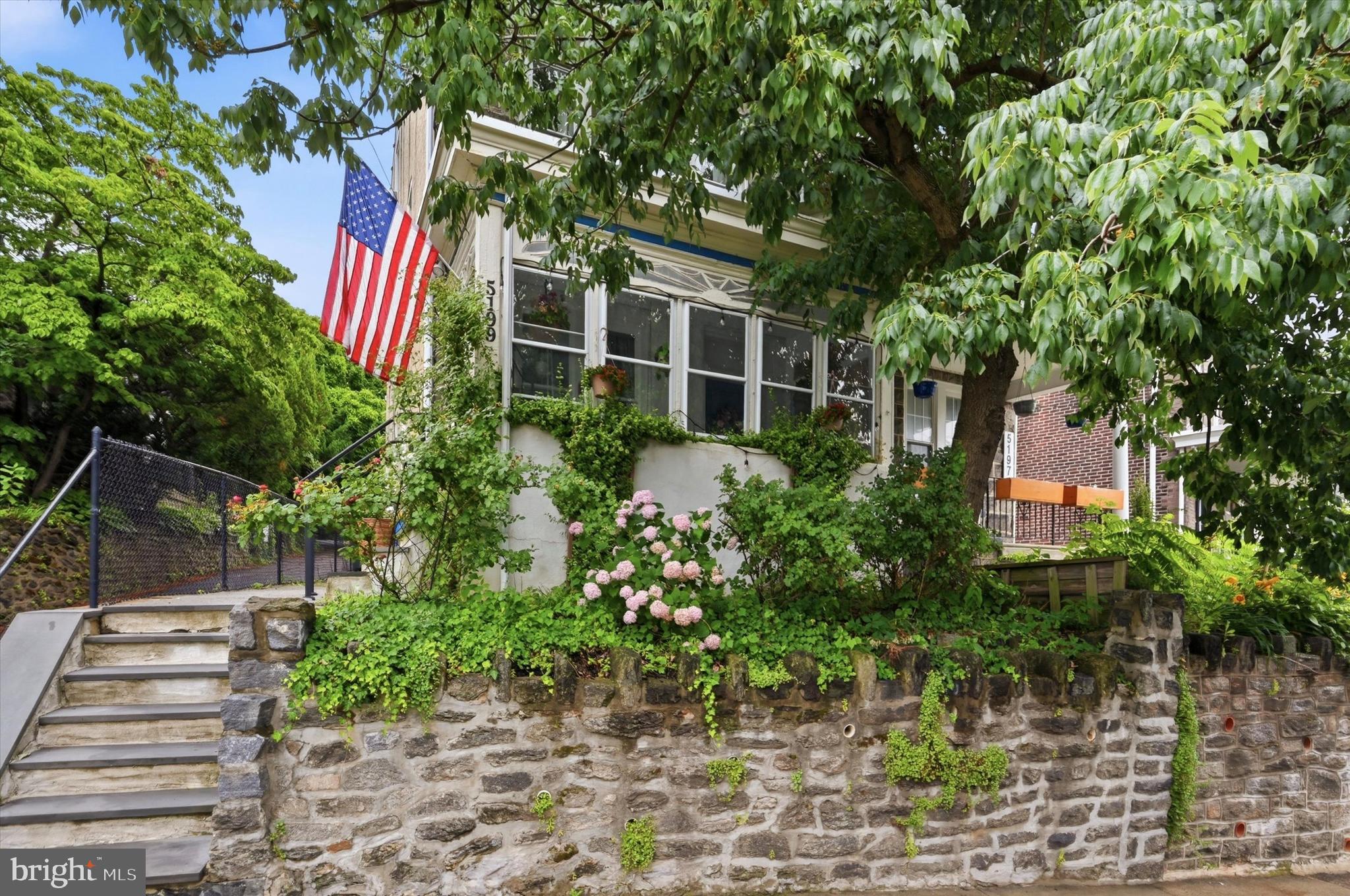Welcome to this beautifully maintained semi-detached 4-story twin home located in the highly sought-after Roxborough section of Philadelphia. From the moment you arrive, you’re greeted by an inviting enclosed front porch with a classic porch swing—perfect for relaxing and enjoying the neighborhood charm.

Step inside to soaring 9-foot ceilings that create an incredible sense of volume throughout the home, paired with an abundance of natural light that fills the living spaces. The main level offers a seamless flow ideal for both everyday living and entertaining, featuring a convenient powder room and laundry area.

At the heart of the home is a fully gutted and tastefully renovated kitchen, designed with the modern chef in mind. It showcases quartz countertops, high-end stainless steel appliances, a dishwasher, pantry, pendant lighting, and peninsula seating for casual dining and gatherings.

The second floor continues with impressively high ceilings and hosts the sleeping quarters. The main bedroom features an exposed organizational closet system, while the second bedroom serves as a flexible home office space. The third bedroom, located at the rear, offers dual exposure with natural light from both side and rear elevations.

On the third floor, you’ll find the spacious fourth bedroom with additional storage features, providing versatility for guests, work, or recreation.

The partially finished basement expands your living space with a secondary family room/game area, while the unfinished portion offers generous additional storage.

Outdoor living is easy with a fenced rear yard and patio, conveniently accessed from the kitchen—ideal for grilling and entertaining. Street parking is readily available.

The care and investment made to the home during Seller's ownership includes a fully renovated chef's kitchen, the renovated partially finished basement with new drywall and carpeting, refinished hardwood floors throughout the main level, the addition of a convenient powder room, relocation of the laundry room to improve functionality, replacement of the original radiator heating system with a new HVAC system and central air (2018), a new roof (2020), and a new water heater (2021). These thoughtful updates enhance comfort, efficiency, and everyday living while complementing the home's original character, creating a move-in-ready property for its next owner. 

Perfectly situated, this home offers exceptional access to public transportation with an impressive Walk Score of 87. Multiple bus routes (#27, #9, and #65) are within one block, and regional rail stations including East Falls, Ivy Ridge, and Manayunk are all within approximately one mile from the home making commuting into the City easy! 

This Roxborough gem blends historic charm, modern updates, and unbeatable convenience—ready to welcome its next owner. Don't hesitate to schedule your showing today and call 5199 Ridge Ave Home! Showings begin on Wednesday, July 1st.