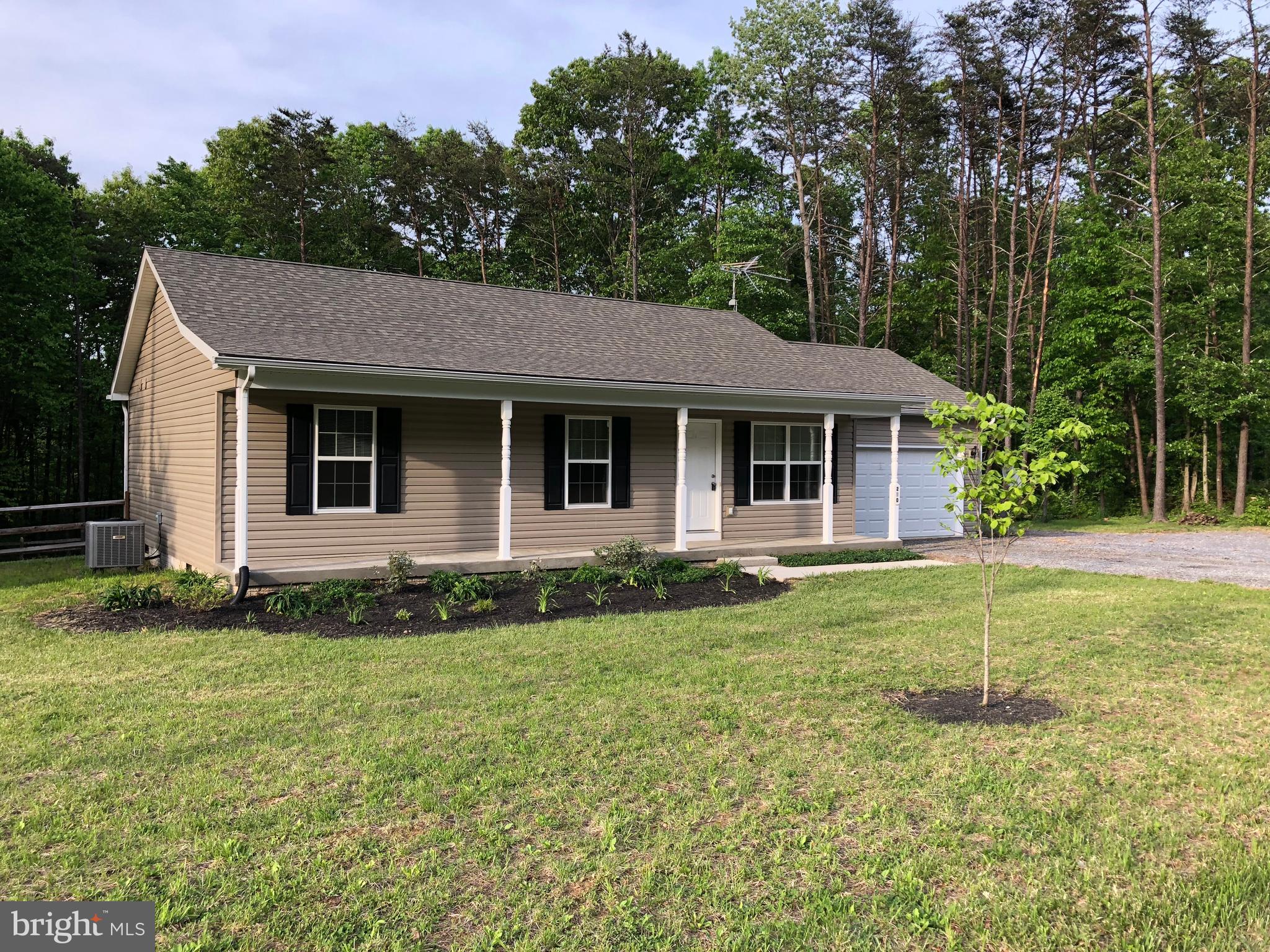 A little slice of heaven. 2 acres, NO HOA, large master bedroom and  bath, huge rear deck, fenced back  yard. Enjoy the sunsets from the front porch.   New carpet and walls painted. Washer and dryer are available. Only 6 miles from I 81 Inwood exist.  Drive to Martinsburg or Winchester less than 20 minutes. Good road with maintenance fee of $150.00 per year.