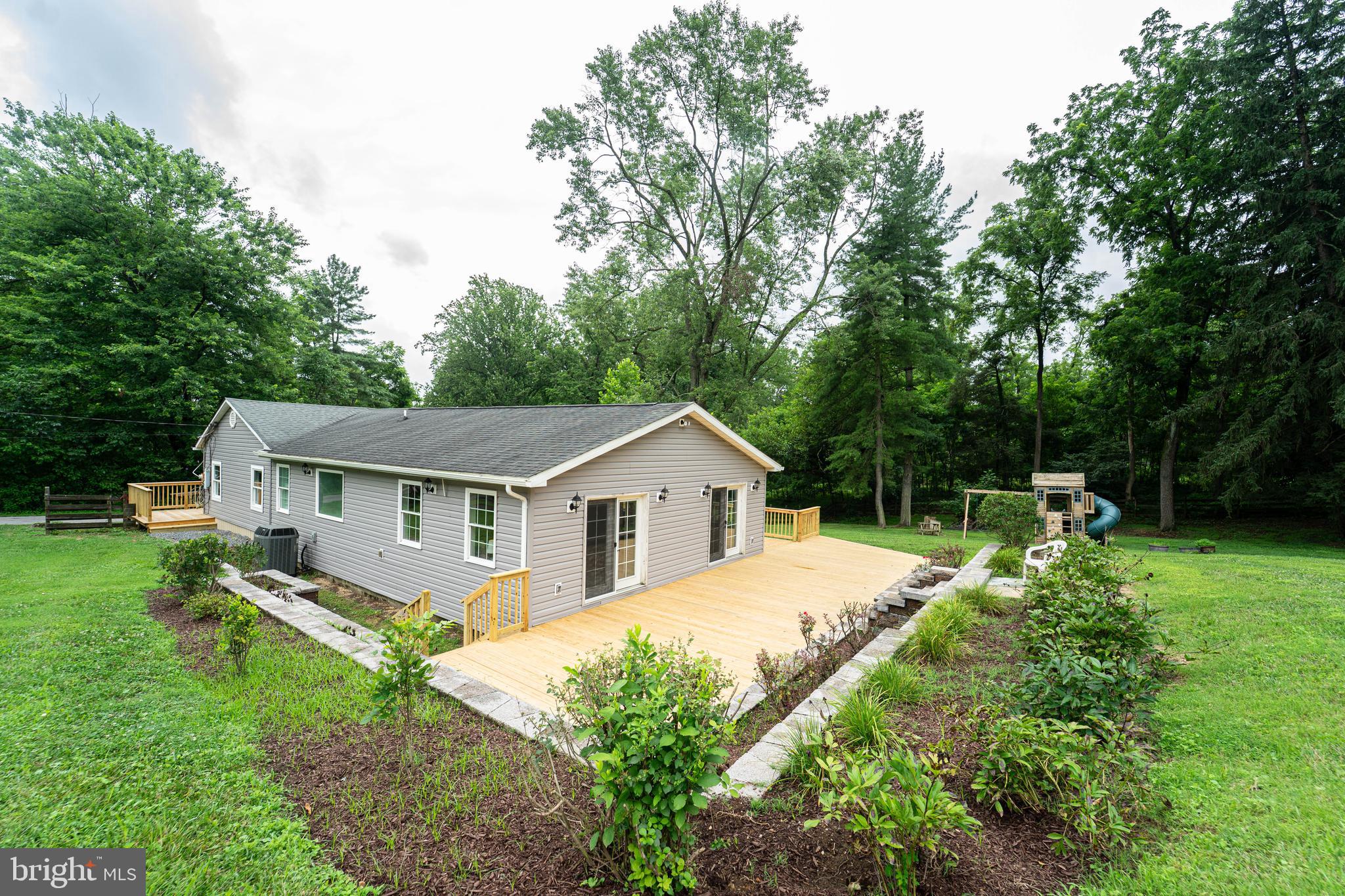 Tucked away on well over an acre of scenic, private land, this beautifully updated rancher in Howard County  offers the perfect blend of modern luxury and peaceful seclusion. Just minutes from the state park, this home feels like a retreat while still being close to everything you need.

Step inside to discover a thoughtfully renovated interior featuring a stunning new kitchen with custom cabinetry, sleek countertops, and stainless steel appliances. The bathrooms have been completely updated with stylish finishes and spa-like touches. The spacious master suite offers a peaceful escape with plenty of natural light and a beautifully updated en-suite bath.

Gleaming hardwood floors flow throughout the home, and a large laundry room adds both function and convenience. Step outside onto the brand-new deck and take in the views of the expansive, flat backyard — perfect for entertaining, playing, or simply enjoying the tranquility of nature.

This one-of-a-kind property offers the space, style, and serenity you've been searching for. Don't miss the chance to make it yours!