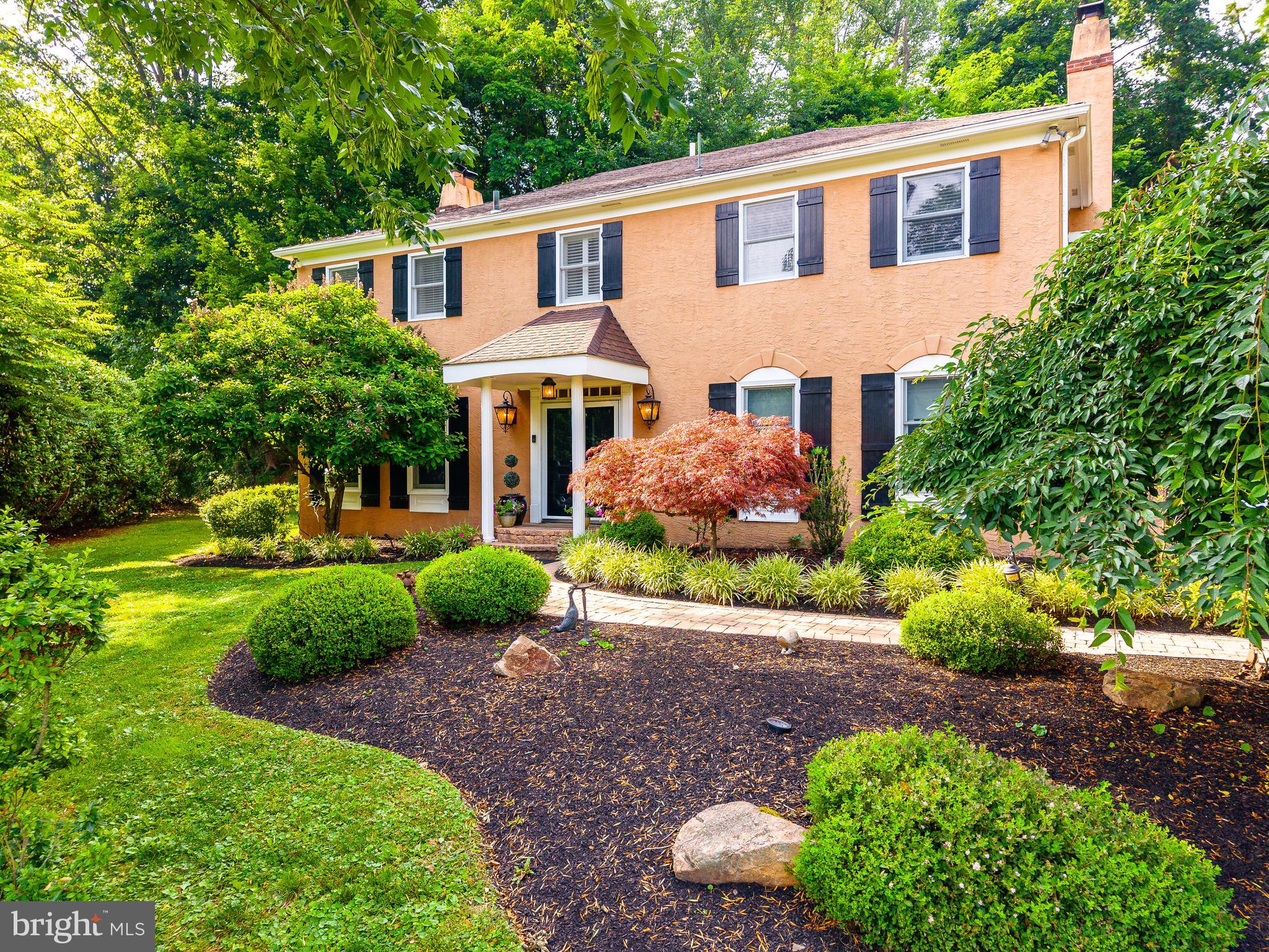 Perched atop a picturesque cul-de-sac and surrounded by 1.52 acres of beautifully landscaped grounds, this beautifully maintained home offers an exceptional combination of privacy, space, and convenience in one of Villanova's most sought-after Lower Merion neighborhoods. Mature trees and  lush landscaping create a peaceful setting that feels worlds away, yet remains just minutes from everything the Main Line has to offer.
Built in 1980, this classic Center Hall Colonial offers 4 bedrooms, 3 full bathrooms, 1 half bathroom, over 3,900 square feet of living space, a finished lower level with a full bathroom and gym, and an attached two-car garage.
A welcoming center hall foyer introduces the home's warm and inviting interior. Rich hardwood floors, elegant moldings, and abundant natural light flow throughout the main living spaces. A private home office with custom built-ins provides the ideal work from home retreat, while a powder room and first floor laundry room add everyday convenience.
Designed for both entertaining and comfortable daily living, the main level offers an exceptional flow between formal and informal spaces. The elegant living room features hardwood floors, a decorative fireplace, and double doors that open directly to the backyard. Adjacent to the living room, the formal dining room is ideally positioned between the kitchen and living spaces and also features double doors leading to the patio, creating a seamless connection between indoor and outdoor living.
At the heart of the home is the beautifully renovated kitchen, updated in 2021 featuring granite countertops along the perimeter, a large quartz center island, Viking gas cooktop with warming drawer, GE Monogram refrigerator, double wall ovens, Fisher & Paykel dishwasher drawers, built-in wine refrigerator, abundant cabinetry, and a full pantry. A sunny breakfast nook overlooking the backyard provides the perfect spot for casual dining, while a custom built-in serving station adds additional storage and functionality.
Overlooking the lush front landscaping, the spacious family room offers a comfortable gathering space centered around a wood-burning fireplace.
The second floor offers four generously sized bedrooms and excellent storage throughout. The primary suite serves as a true retreat, featuring three separate closets and a spa-inspired bathroom complete with heated floors, steam shower, soaking bubble tub, Toto toilet, custom vanity, and extensive built-in cabinetry. Three additional bedrooms are served by a spacious hall bathroom with a double vanity and tub/shower combination.
The fully finished lower level significantly expands the home's living space with a large recreation room, dedicated gym area, and full bathroom, offering exceptional flexibility for a variety of lifestyles.
Outside, the property transforms into a private backyard oasis. Expansive patios, mature landscaping, colorful gardens, and sweeping lawn areas create a peaceful setting for outdoor dining, entertaining, and relaxation.
Additional improvements include updated flooring and lighting, first floor windows, front portico and walkway improvements, rear patio enhancements, a full house Generac generator (2015), new roof (2024), HVAC zone (2024), and numerous thoughtful upgrades throughout.
Located within the award-winning Lower Merion School District and within minutes of Black Rock Middle School, this exceptional property is also moments from Villanova, Bryn Mawr, Wayne, regional rail, shopping, dining, country clubs, major commuter routes, and the beloved Stoneleigh walking paths. A rare opportunity to own a beautifully maintained home on one of Villanova's most desirable cul-de-sac settings, where timeless architecture, modern improvements, exceptional outdoor spaces, and a remarkable sense of privacy come together to create an extraordinary Main Line lifestyle.