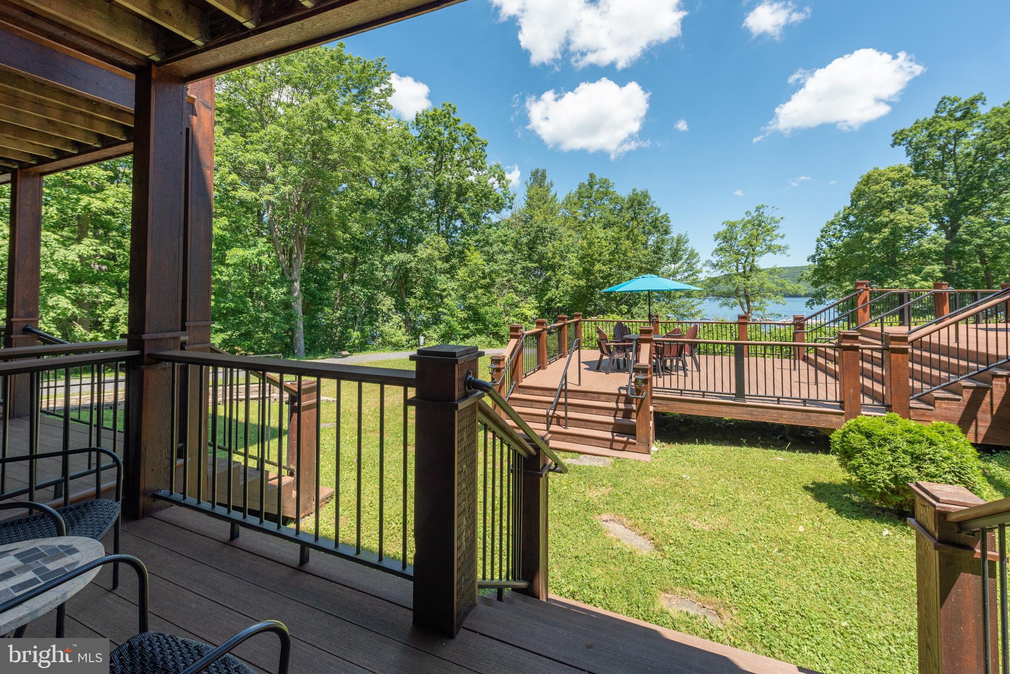 Ground-floor end unit with lake views at Silver Tree Suites! This inviting one-bedroom layout features a gas fireplace, full bath with tub/shower, and a tidy kitchenette equipped with a microwave, dishwasher, and full-size refrigerator. Balcony doors open to fresh Deep Creek air and filtered lake views, with a private deck that is perfect for relaxing after a day on the water. Enjoy a variety of community amenities, including a sauna, fitness center, game room, and more. This condo is sold turn-key and fully furnished, featuring efficient ductless heating and A/C units for year-round comfort. The monthly condo fee conveniently covers exterior maintenance, common grounds, and lakefront access. Don’t miss your chance to own a premium lakefront property—without the premium price tag!