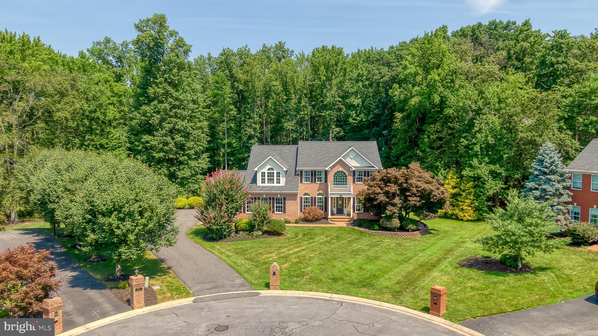 Welcome to Woodcrest! More than 5,000 square feet of beautifully updated living space situated on a quiet cul-de-sac backing to trees in Fallston. This exceptional home features numerous improvements completed within the last five years, including: New roof, carpet, tile flooring, renovated lower level, office, three remodeled bathrooms, updated main level laundry room/drop zone, rebuilt front porch, widened driveway, regraded yard, and updated the maintenance-free deck. PLUS, a VA assumable mortgage at an incredible 2.25% interest rate for qualified buyers. A grand two-story foyer welcomes you with hardwood floors. You'll find a dining room, private office with French doors, and a soaring family room with gas fireplace. The gourmet kitchen offers granite countertops, center island, breakfast bar, stainless steel appliances with double wall ovens, and a bright morning room overlooking the private backyard. A flexible main level bonus room is ideal as a playroom, second office, or potential fifth bedroom. Upstairs, the spacious primary suite features a sitting area, walk-in closet (plus two additional closets), and renovated spa bath. There are three more bedrooms along with another full bathroom to complete this level. The finished walkout lower level includes a large rec room with wet bar, full bath, bedroom being used as an exercise room, den, and access to the paver patio. Enjoy the expansive deck with screened gazebo overlooking the level backyard, plus an oversized side-entry 2½-car garage. This is what you've been waiting for! Be in before the school year.