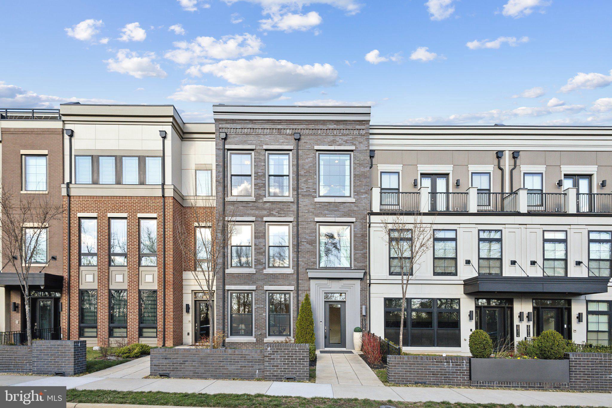 Welcome to One Loudoun! This absolutely stunning 4-bedroom, 3 full bath, 2 half bath grand townhome spans an impressive 4 levels and over 4,300 sq ft of luxurious living space. A standout feature of this home is its VERY OWN PRIVATE ELEVATOR — a rare touch that brings both convenience and sophistication to each floor.

As you enter on the first level, you’re greeted by a spacious, light-filled area that can easily serve as a home office, second family room, or versatile flex space to suit your lifestyle — complete with a convenient half bath.

The second floor is where the heart of the home comes to life with a breathtaking open-concept living space. The grand, all-white chef’s kitchen boasts an enormous center island with seating for five, light granite countertops, striking overhanging light fixtures, a full wall of custom oversized cabinetry, herringbone subway tile backsplash, and Wolf and Sub Zero appliances. A full walk-in pantry with five rows of built-ins offers plenty of storage. 

Adjacent to the kitchen, the formal dining area features a stunning centerpiece light fixture that adds an elegant touch, and from here, you have direct access to your private balcony with elevated views. The spacious living room offers a cozy yet modern feel with a custom-built fireplace and three large windows that flood the room with natural light.

On the third floor, you’ll find the bright and oversized primary suite with tall ceilings, a true retreat within the home. The en-suite bathroom is absolutely stunning, featuring marblesque flooring, an extended double vanity, a walk-in glass shower, and a modern standalone soaking tub. The walk-in closet offers two full walls of custom white built-ins and a center window for an airy, boutique feel. Two additional spacious bedrooms on this level provide ample closet space and oversized windows to let in even more natural sunlight, accompanied by a full hallway bathroom.

The fourth and final floor offers an incredible open entertainment space, perfect for a second family room or media space, complete with a full wet bar, wine cooler and ice machine — ideal for hosting. French doors lead to your private rooftop terrace with scenic views, featuring a rectangular stone fire pit and built-in grill, creating an unforgettable indoor/outdoor experience. Don't forget to use your fully electic awning allowing for shade on those hot summer days! Lastly on this level is the fourth bedroom with its own modern private en-suite and oversized walk-in closet, offering the perfect private space for guests or additional family members.

Amenities: Club house, outdoor pool, playground, volleyball courts and jogging path.

Parking Details: Attached private 2-car rear entry garage.