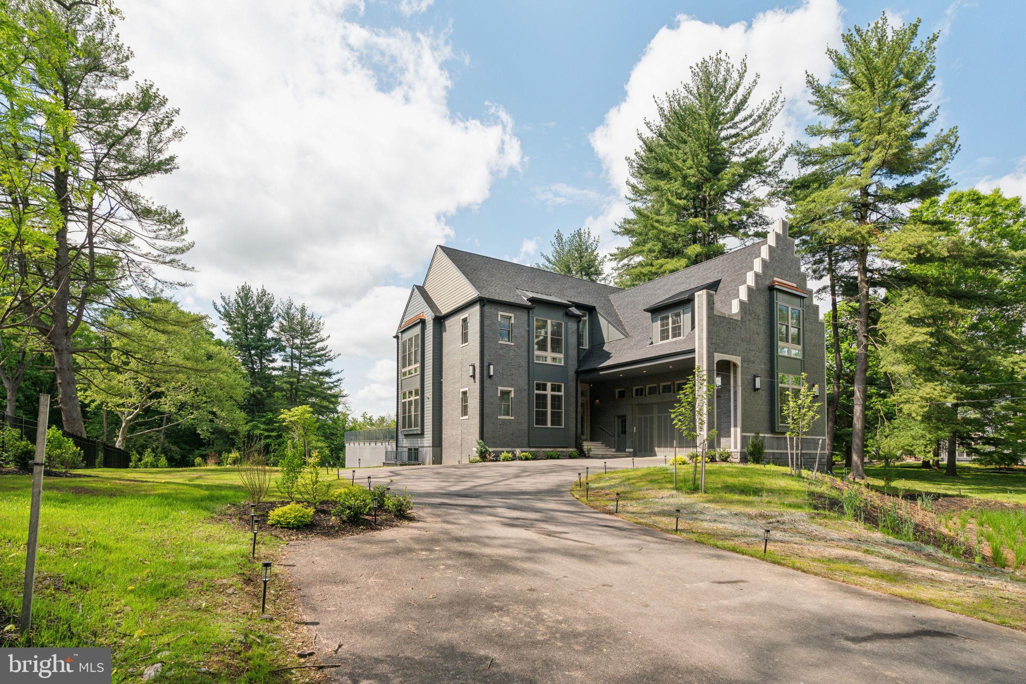 Welcome to 227 Northwestern Ave, this spectacular new construction home is situated on a quiet street neighboring Wissahickon Valley Park. The setting feels bucolic, located in highly sought-after Springfield Township. It offers a rare opportunity to own a very private estate with proximity to hiking and biking trails that athletes dream of while remaining minutes from Chestnut Hill and a 25 minute drive to downtown. The main floor with 11’ ceilings is flooded with natural sunlight and features a gourmet kitchen with oak cabinets, quartz countertops and backsplash, GE Monogram appliances, two sinks, open shelving and a walk-in pantry. The dining area and family room are designed with open concept living while architectural elements create an intimate sense of coziness. The living room is breathtaking with 22’ ceilings and a gas fireplace. Here also you will find expansive floor-to-ceiling windows framing endless views of trees. Step out onto the slate patio which is perfect for outdoor entertaining. The first floor is complete with an en-suite bedroom and convenient mudroom and a powder room. The second floor with 10’ ceilings features 4 en-suites all with floor-to-ceilings windows and walk-in closets with gorgeous tree top views. There is an ideally situated laundry room with GE Profile appliances and a well-equipped laundry station with top and base cabinets, quartz countertops and a sink. The primary suite is private with a large bedroom, sitting area and walk-in closet with custom cabinetry. The bathroom feels like a spa with double vanities, water closet, 67” free standing soaking tub and and a walk-in shower with dual rain shower faucets and body spray fixtures. The lower level with walk-out features another private en-suite and a separate wing with another full bathroom and offers plenty of opportunities as a home gym, play area and/or a home theatre. There is much more: 3-zone HVAC, Andersen windows, security system, hardwired speakers, multiple exterior cameras, gated entry with intercom and tray ceilings with light boxes throughout make for unparalleled, modern and well-lit space! This house is minutes from the restaurants and shopping in Chestnut Hill, Manayunk, Plymouth Meeting and Conshohocken. Close to the Morris Arboretum, Woodmere Art Museum, train station and several golf courses and country clubs. Easy commute to Center City, King Of Prussia, 76, 676, 476 and the PA Turnpike. Less than a 2-hour drive to NYC. 1-year builder warranty included. The property has a Phila zip code for postal purposes but is located in Springfield Township and Springfield School District.