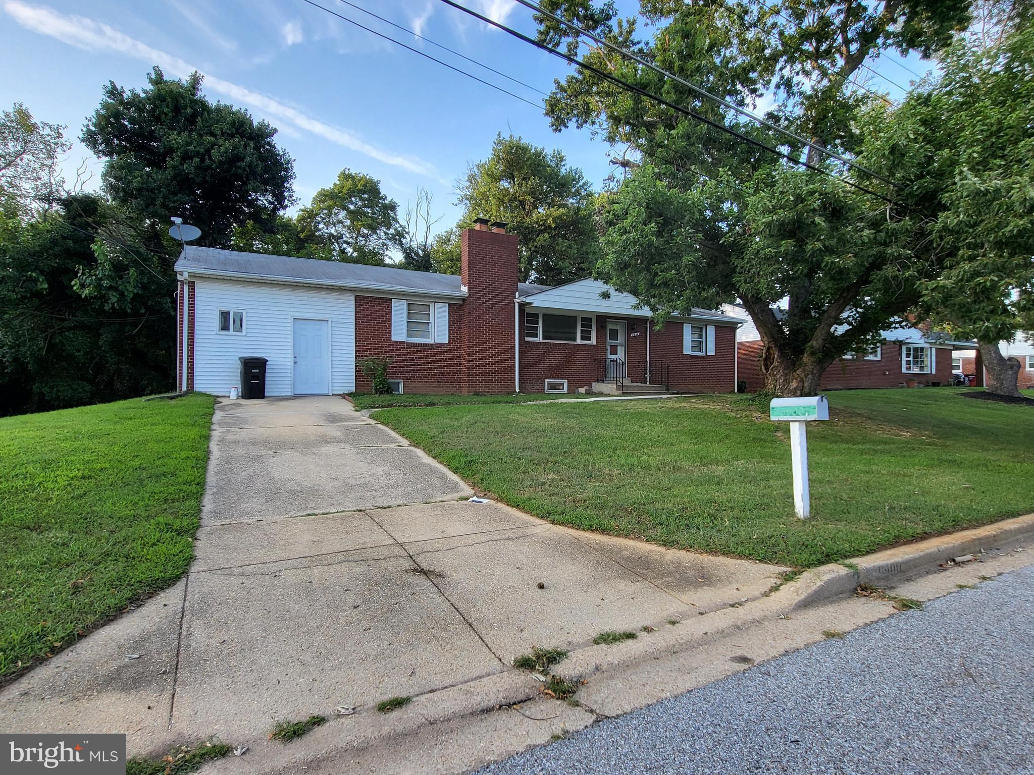 PRICE ADJUSTED- Ready, ready. Spacious, Multi-generational home, CONVENIENTLY located in  CLINTON - a truly roomy 4-bedroom, 4-full bath home that's way more spacious than it looks from the outside with this corner lot,  there is extra parking with this solid brick home. You'll be pleasantly surprised by just how much this single family house offers! There is still opportunity for you to make it your own - Buy & Hold or Income Property.... So much potential.

The main level is super comfortable and great for entertaining. It has three good-sized bedrooms, offering plenty of private space, and two full bathrooms for everyone's convenience- one with a petite en suite. The kitchen has granite and updated/new appliances with room for a table, perfect for casual meals, and there's a separate dining room for more formal dinners. Plus, there's a versatile den that's perfect for a home office or a cozy library for reading/meditation. The living room with hardwood floors is a central spot to hang out, and that beautiful brick fireplace makes it extra cozy on chilly evenings.

Downstairs, you'll find an entirely self-contained living area that's incredibly flexible. This level has its own entry from upstairs and outside as well as its own kitchen with more granite and updated appliances including space for a table, great for independent living or extended family. There are also two more full bathrooms. You'll find a comfy bedroom and a large family room with another inviting brick fireplace – perfect for movie nights! A dedicated laundry room adds to the convenience. And don't forget the two "flex rooms" that you can use however you like – a home gym, craft room, media room, or extra storage!

Beyond all these awesome features, the lower level actually has the potential to bring in some extra cash. With its separate amenities, it could easily be an Accessory Dwelling Unit (ADU), giving you a valuable rental income or a private spot for multi-generational living.

And let's talk about the location – it truly lives up to the "CONVENIENT CLINTON" name. It's perfectly situated with excellent access to Joint Base Andrews, making it ideal for military personnel or frequent travelers. Commuting is a breeze with easy access to MD Route-5 and the Capital Beltway/I-95, connecting you seamlessly to the wider metro area. Book your appointment with Marie today!