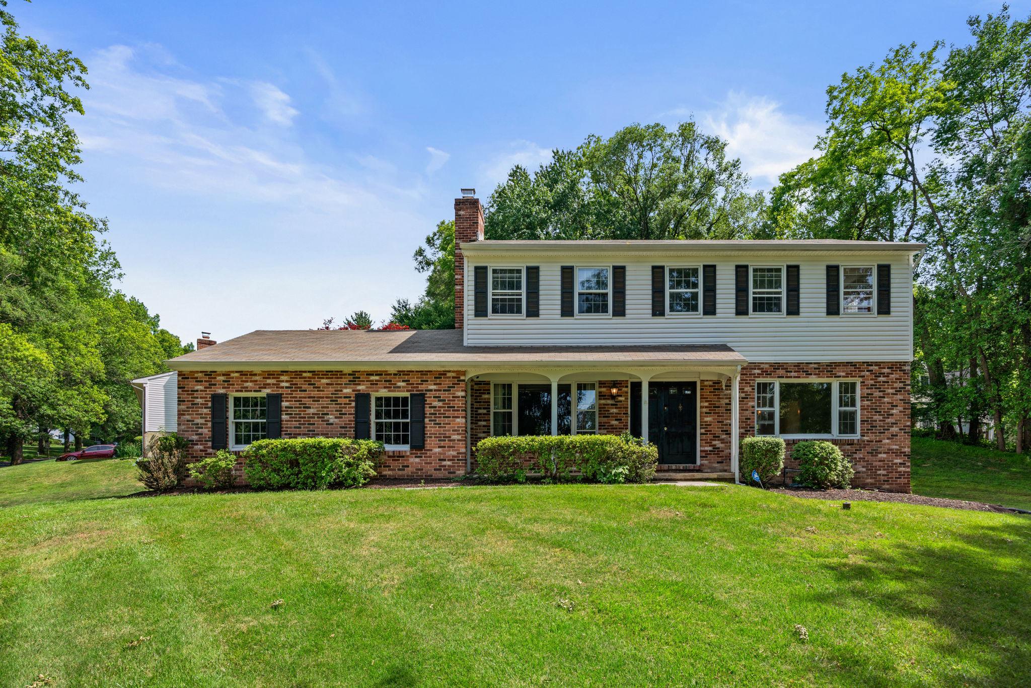 Expected on the market Monday, June 8th.  Seller prefers MD Title Works Unlimited.
This 4 bedroom, 2.5 bath colonial is perfectly positioned beside the entrance to Font Hill park, offering peaceful wooded views and easy access to walking paths and outdoor recreation right from your front porch. A separate side entrance leads directly to the 2-car detached garage and a convenient main level laundry room and half bath.
Inside, the updated kitchen features brand new flooring, plenty of storage in the pantry, and room for a kitchen table. The spacious main level also includes a formal dining room that could easily serve as a home office, a welcoming living room, and a cozy family room with a wood burning fireplace and built-ins. You’ll love the unique wood beamed ceilings that add warmth and character to the main level.
Upstairs, the generous primary suite includes a walk-in closet and ensuite full bath. Another bedroom adjoins the primary, with two additional bedrooms and a second full bath completing the upper level. Hardwood floors have been refinished throughout the first and second floors, and the home has been freshly painted in a soft, neutral palette.
The walk-out basement is partially finished and ready for your personal touch, offering shelving and rough-in plumbing already in place for a bathroom. This space can easily be used as a craft room, media room, a home gym, or a guest space.
Tucked into a quiet neighborhood with paved paths and easy access to Font Hill Wetland Park, Miller Branch Library, major commuter routes, parks, golf courses, and historic Ellicott City, this home offers the perfect blend of comfort, convenience, and connection to nature.