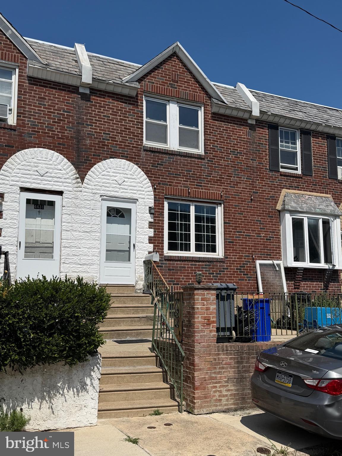 This charming interior row townhouse in the desirable Holmesburg neighborhood offers a perfect blend of comfort, convenience, and opportunity. Built in 1950, this well-maintained home features 1,078 sq. ft. of living space and has been freshly painted throughout. A welcoming front patio introduces you to the property, perfect for relaxing outdoors. Step inside to find classic hardwood flooring in the entryway, leading to a main level featuring durable laminate flooring. Upstairs, brand-new carpeting runs through the hallway and all three spacious bedrooms, while the full bathroom features ceramic tile flooring and a jetted tub. The home is move-in ready with its fresh paint and new flooring, yet leaves perfect areas for the new homeowner to update and personalize to their own taste. Additional highlights include an unfinished basement with an outside entrance for excellent storage, an attached garage, and off-street parking. Conveniently located near local parks, schools, and public services, this property is being sold in as-is condition. This lovely house is just waiting for you to walk through the door, bring your own personal touches, and truly make it your home.