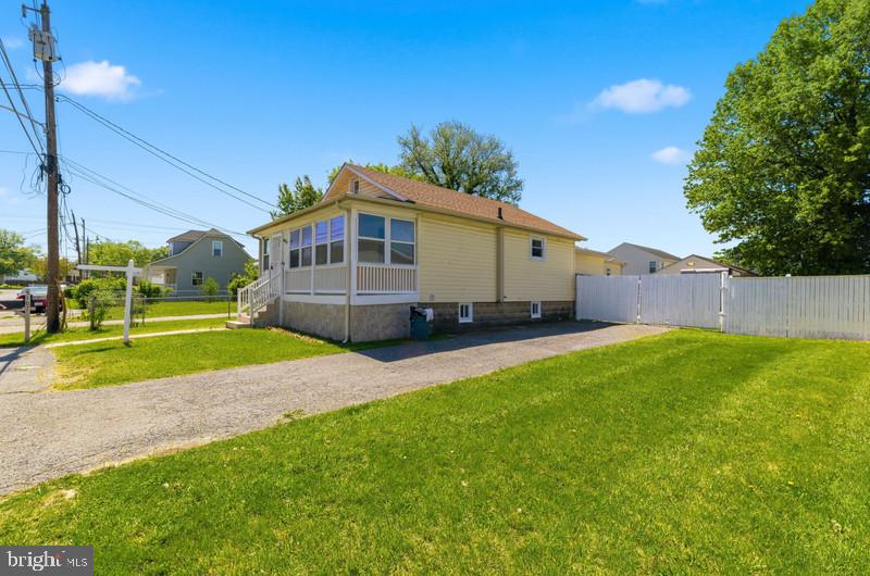 Welcome Home to this move in ready,  3 bed, 3 full bath, beautifully refreshed home boasting brand‑new LVP flooring, fresh paint, and a layout designed for comfort and versatility. A welcoming sunroom opens to a bright living/dining room with vaulted ceilings, leading to the kitchen, three bedrooms, and two full baths. The finished lower level adds incredible value with a full bath, multiple bonus rooms, and direct access to the fully fenced backyard. Full privacy fenced rear yard with detached garage, plus a large driveway for additional parking. A fantastic opportunity in a prime location.