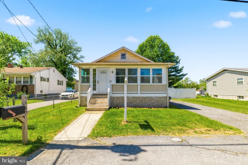 Welcome Home to this move in ready,  3 bed, 3 full bath, beautifully refreshed home boasting brand‑new LVP flooring, fresh paint, and a layout designed for comfort and versatility. A welcoming sunroom opens to a bright living/dining room with vaulted ceilings, leading to the kitchen, three bedrooms, and two full baths. The finished lower level adds incredible value with a full bath, multiple bonus rooms, and direct access to the fully fenced backyard. Full privacy fenced rear yard with detached garage, plus a large driveway for additional parking. A fantastic opportunity in a prime location.