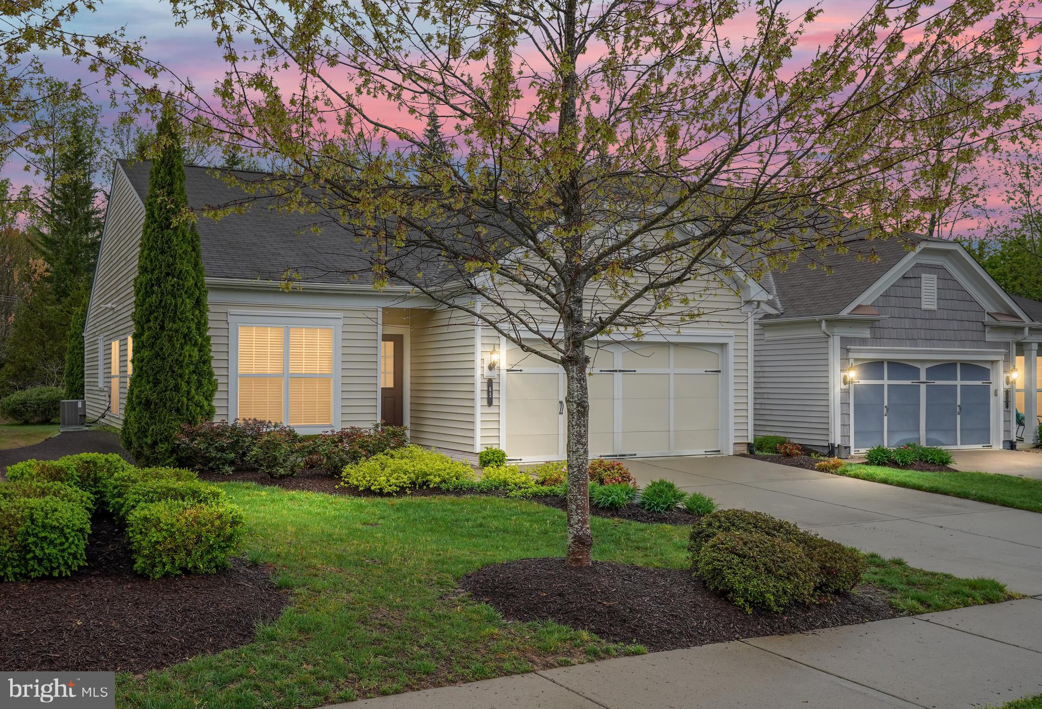 Welcome to 65 Denison St – Maintenance-Free Living in Celebrate Virginia North! Nestled in the heart of the highly sought-after Active Adult community of Celebrate Virginia North, this beautifully maintained 2-bedroom, 2-bathroom home offers 1,664 square feet of light-filled living space. Designed for both comfort and flexibility, this home features a traditional yet open floor plan that effortlessly adapts to your lifestyle needs. Step inside to find gorgeous wood flooring, elegant crown molding, and classic wainscoting that add a touch of sophistication. Just off the foyer, French doors open to a versatile flex space, ideal as a home office, cozy den, or even a third bedroom if desired. Entertaining is a delight in the formal dining and living rooms, where stately pillars define each space while maintaining an open and inviting feel. The well-appointed kitchen is the heart of the home, boasting a spacious peninsula with breakfast bar, offering additional seating, ample prep space, and extra storage. This space flows effortlessly into the family room, complete with a charming nook—perfect for a breakfast area or reading retreat. A wall of windows floods the living area with natural light and provides seamless access to the stamped concrete patio, where a private, tree-lined backyard creates the perfect setting for relaxation and outdoor enjoyment. The primary suite is a true retreat, offering peaceful rear-facing views, a large walk-in closet, and an en-suite bath featuring an easy-access shower. A second bedroom with Jack-and-Jill bath access ensures guests or family members feel right at home. Additional conveniences include a mudroom/laundry room with utility sink and direct access to the spacious 2-car garage. Living in Celebrate Virginia North means enjoying a resort-style lifestyle with full lawn maintenance and access to an impressive 30,000+ sq. ft. clubhouse featuring indoor and outdoor pools, a fitness center, billiards, pickleball and tennis courts, walking trails, putting greens, and a full-time lifestyle director to keep the social calendar full. Ideally located just minutes from shopping and dining, with a quick drive to historic Downtown Fredericksburg, this home offers the perfect blend of elegance, comfort, and convenience. Come experience the best of 55+ living—schedule your showing today!