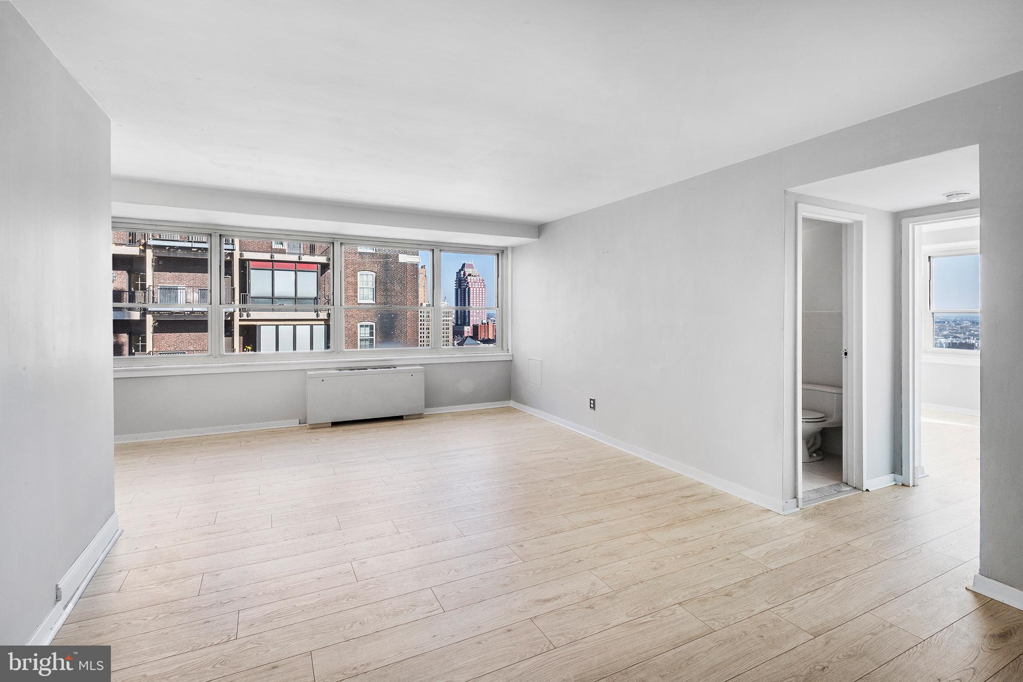 Great 16th floor corner unit on Rittenhouse Square. Located on the South Eastern corner, this condo has dramatic views and incredible natural light. This is the most sought after 1 bedroom line facing South in the building. Spacious living and dining areas with large galley kitchen. The bedroom is the highlight with 180 degree views including the perfect view of the incoming planes approaching landing at Philadelphia International Airport. Night views are special. Updated bathroom. Newer flooring, countertops, kitchen appliances, and window treatments. 3 closets. A wall of windows in living room + bedroom. Beautifully located at the quiet, south side of Rittenhouse Square, the Rittenhouse Savoy offers glorious park-side living in Philadelphia's most sought-after neighborhood. The handsome 1950s building welcomes visitors with a midcentury modern lobby, and residents enjoy 24-hour desk services, a spectacular brand new roof deck with panoramic views and fitness center. Short walk to UPENN, Drexel University, Chop, Jefferson Hospital, 30th Street Station, central business district, Kimmel Center, Schuylkill River Park, high-end retail and Philadelphia's best bars, cafes, and restaurants. No Dogs. Condo fees include ALL utilities except for Internet & cable. There is a flat $79/mo cable bill charged by the building to all units for high speed internet and an Xfinity cable modem. *the unit has a combo washer/dryer. The stackable unit in the photos is no longer there.