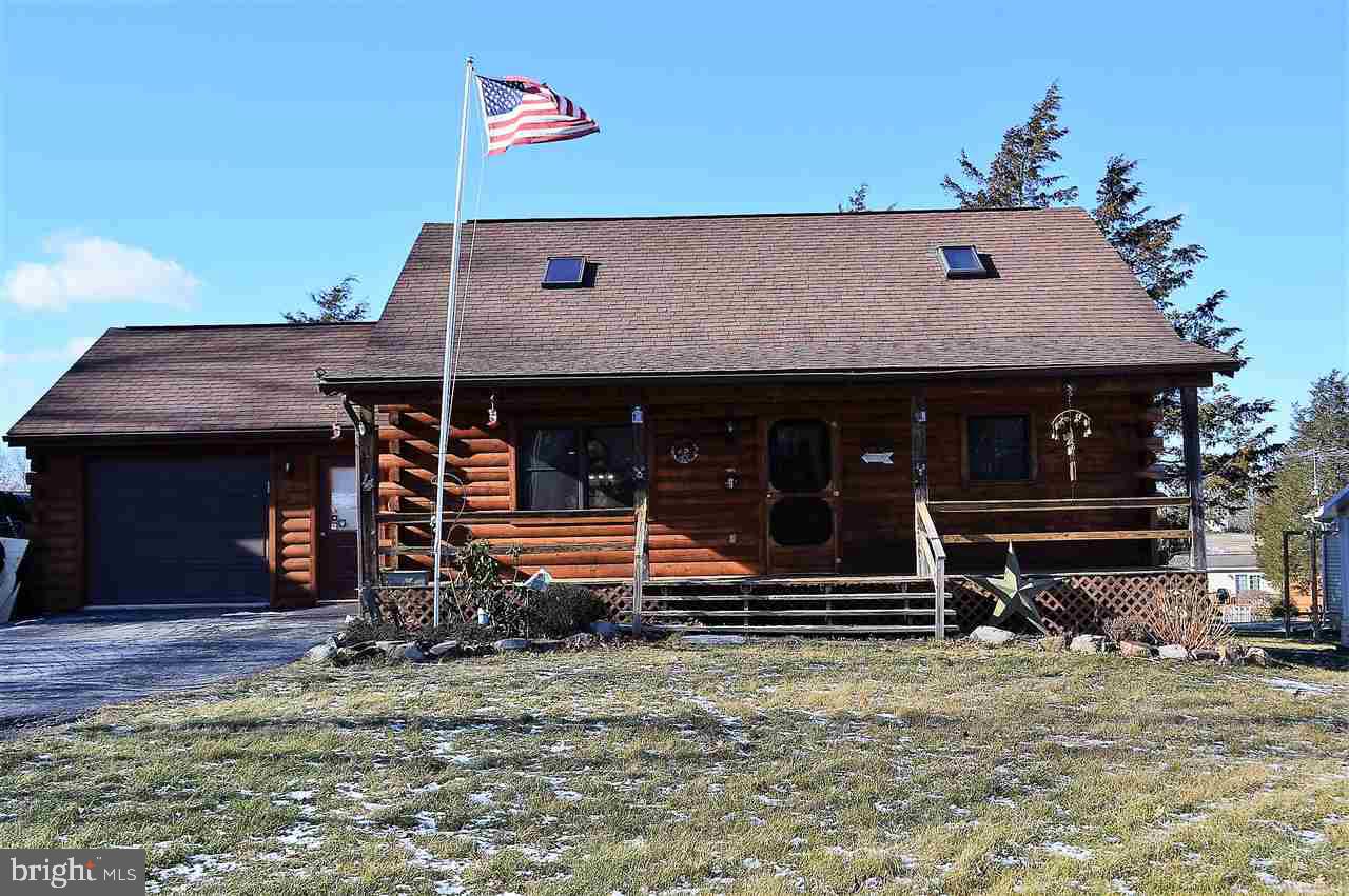 Rock on your front covered porch in this log home w/open fl plan cathedral vaulted ceilings skylights exposed beams & beautiful log interior Kit is fantastic for entertaining w/lg center island breakfast bar dining area+all appliances incl Loft style Owners suite has its own private bath Over sized 1 c gar nice deck level yard The exterior was sealed in November with a transferable warranty. enjoy boating, fishing, tennis the pool and sunsets.