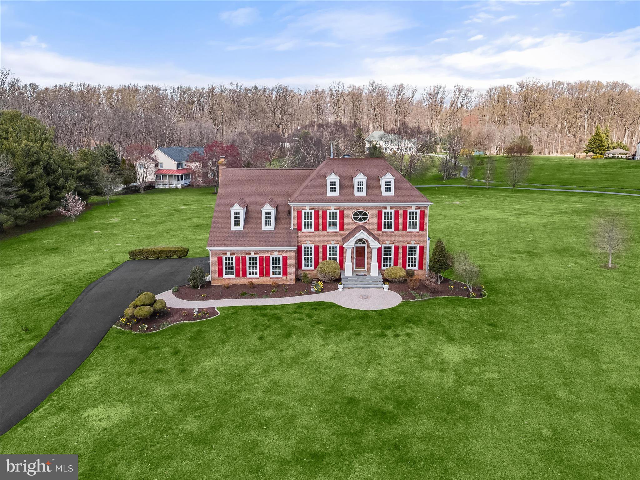 Prepare to be charmed by this spectacular five bedroom, three full & one half bath, luxury property featuring 3,712 FINISHED SQUARE FEET, perfectly sited amidst lush landscapes, pastoral & scenic vistas, including many fruit trees ( apple, pear, persimmon, peach & blueberry) & commanding panoramic views, this property epitomizes customization & elegance, offering a lifestyle of unparalleled  tranquility, serenity & comfort. From the moment you arrive, the grandeur of this all brick front estate, leaves an indelible impression, w/a Stately, expansive front yard, an extended, private, just resurfaced, asphalt grand driveway, which can accommodate 10 vehicles, a 2 car side loading garage w/Tesla charger & a brand new paver walkway ushers you to the brand new flagstone front porch w/ architectural columns. A showpiece of design & craftsmanship, the residence seamlessly blends classical elegance w/contemporary flair, creating a timeless sanctuary of beauty & grace. Step inside to discover a world of sophistication. Generous living spaces adorned w/refined finishes & exquisite detailing , evoke a sense of grandeur & prestige, setting the stage for lavish entertaining & intimate gatherings alike. Updated kitchen w/tile backsplashes, under cabinet lighting, stainless steel appliances, ( including  five burner oven-range, built in microwave, dishwasher, refrigerator) granite countertops & convenient/versatile center island, built in mail/work station & morning area.  A towering hardwood floored, grand entrance foyer ushers you into the home. On your left is a convenient front, private office, w/ new refinished hardwood flooring, Opposite the private office, to the right of the foyer, transitions to the formal living room, adorned w/crown molding & gleaming hardwood floors, adding extra entertaining capacity. Adjacent & open from the living room is a large formal dining room, also detailed with crown molding & resting on shiny new resurfaced hardwood flooring, offers breathtaking views of the lush green open space vistas & frequent deer & occasional  red fox sightings, is perfect for large family & friend gatherings. The dining room conveniently transitions to the large eat in kitchen with tile flooring and a sunken family room with a centered, cozy brick gas burning fireplace, is great for warm cozy nights, with the additional benefits of warming your home and heart. Brand new double sliding doors welcomes your family and guests to a colossal size wood deck framed in by LED rope lighting with expansive rear yard estate lawns views and manicured grounds, the gazebo and peaceful waterfall feature. A powder room bath, and mud room with built in's for coats, jackets, boots/shoes, round out the main level.
Ascend the magnificent hardwood & iron baluster staircase to the palatial master suite, a haven of tranquility & indulgence. With its lavish proportions, 2 large size walk in closets, two skylights, sitting area & updated decadent luxury bath, this private oasis offers a respite from the demands of the workday, promising restful nights and rejuvenating mornings. Three other very generous sized bedrooms, an updated full hallway bath, & convenient upper level laundry room, complete the second level. Beneath the elegant facade of this remarkable residence, lies a fully walk out lower level w/recreation room, bonus room & 5th bedroom or office & a full bathroom, making this home ideal for multi-generational living. Nested in an exclusive enclave of homes, this prestigious estate offers the ultimate in privacy & seclusion, yet is just moments away from fine dining, shopping, entertainment, & recreational amenities that highly sought after Clarksville has to offer. With convenient access to major thoroughfares & airports, the world is at your doorstep. A rare opportunity to own a piece of luxury real estate that transcends the ordinary, zoned to the highly acclaimed, award winning River Hill HS. New Roof & skylights, 38 windows & sliders