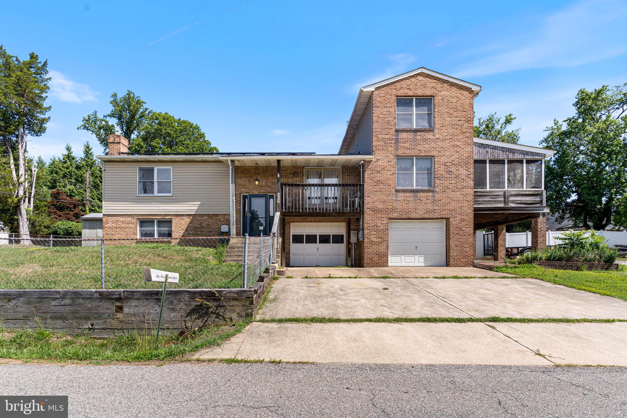 Opportunity to obtain a spacious home in a community with beach access.  There are fees for the beach access, which is owned by Calvert County.   It's within walking distance and also offers a large picnic area.
The home is being sold as is by the estate.  The special features include new carpet on the main level and a new roof between 2021 and 2022.  Solar panels have been installed and will be paid in full at closing. The family is working on cleaning out the home, which is why we haven't displayed pictures of all the rooms.  There are 2 bedrooms on the main level, and a 3rd bedroom was converted into a laundry/storage room.  There is also a w/d hookup in the basement if you want to convert that room back to a bedroom. The lower level is partially finished and needs renovation. There is a wood stove in the lower-level family room that heats the house during a cold spell.  There are 2 spacious garages, currently full of belongings. The screened-in porch is great for entertaining and very large. There is a covered area for parking 2 cars or grilling, and plenty of concrete driveway spaces for parking. The front yard is fenced in to keep the children and pets safe.  The home is being sold as is by the estate.