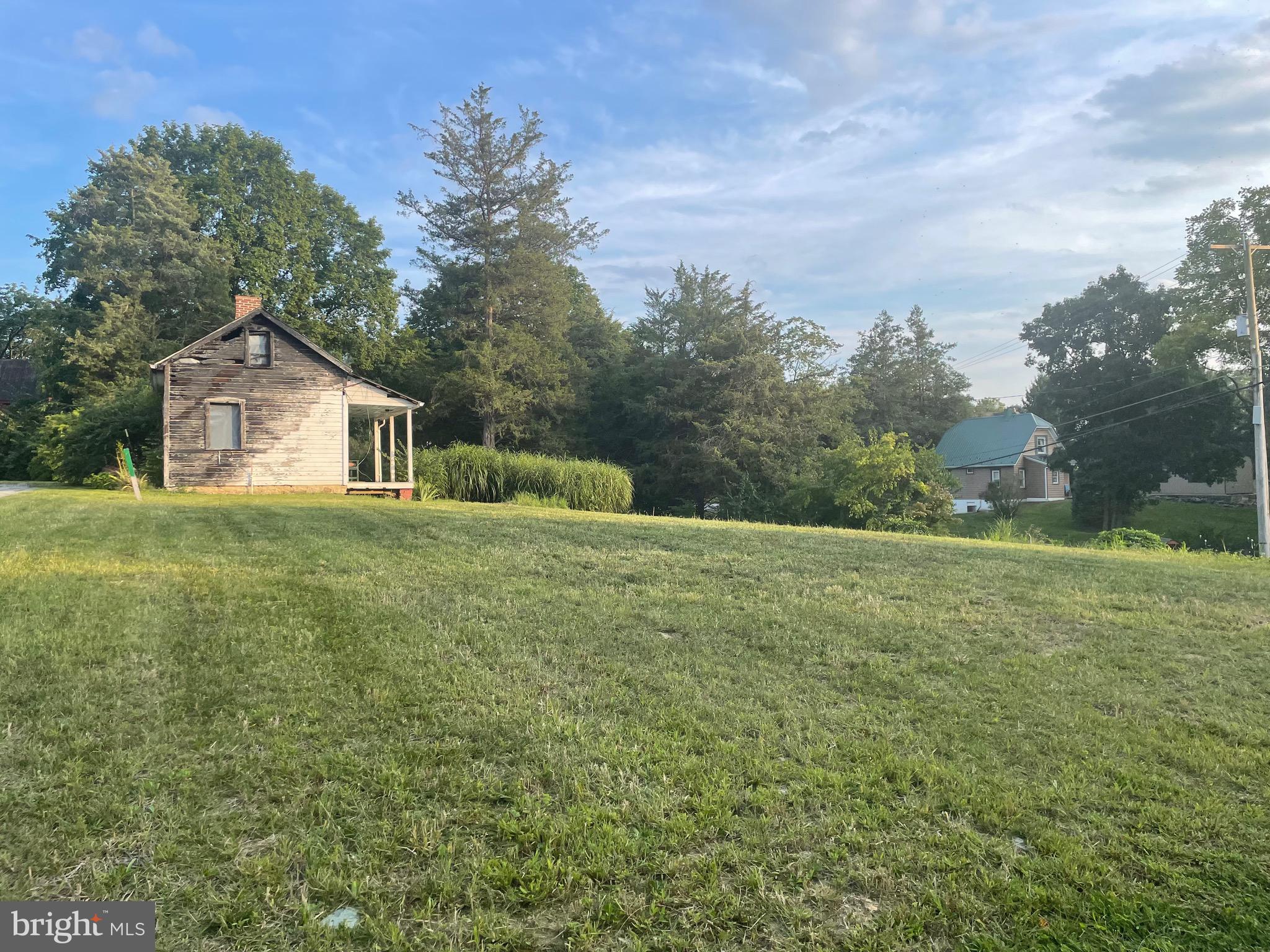 Amazing opportunity to build on this beautiful 1.11 acre lot that already has established buildings!  This spacious parcel has public water and sewer, great views ,outbuildings include a garage, summer kitchen (good for storage) and barn with lots of storage!  Natural gas available! Call for details.  The home that was on the property was destroyed by fire.  This is your chance to build a brand new home to complement the existing improvements.  Plenty of parking too!