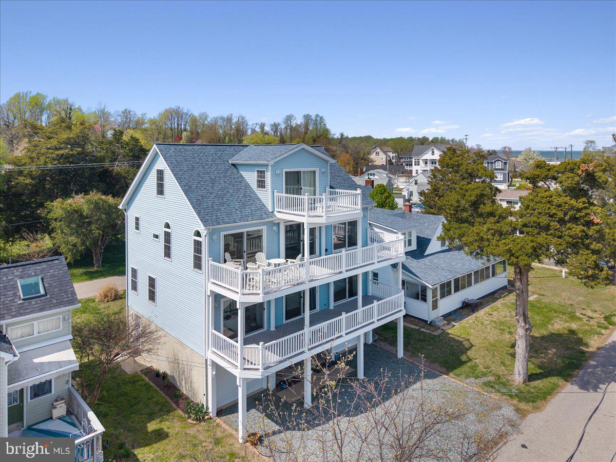 If you can live anywhere, why not live with water views, your own community beach and beautiful sunrises everyday?  Looking for a beach lifestyle without Bay Bridge traffic? This stunning Waterview home in Huntingtown offers access to a private beach on the Chesapeake Bay with convenient water access just across the street. Featuring over 4,000 square feet, this property is ideal as a second home, vacation home, or potential multi-family retreat. Enjoy breathtaking waterfront-style views from all four levels, with 4 bedrooms including 3 with en-suite baths. Multiple decks off the primary suite, bedrooms, kitchen, and upper level capture the beauty of the Bay. The lower level is designed for beach living with a private entrance, rinse area, half bath, and wet bar. Additional features include a two-car garage, fresh interior paint, elevator shaft for future installation, community beach access (3 entrances), and a rentable clubhouse. Conveniently located under an hour to Washington, DC, Alexandria, and within easy reach of Annapolis. Located 10 minutes from Chesapeake Beach & North Beach! A perfect opportunity to enjoy relaxed Chesapeake Bay waterfront living without the commute. Two car garage gives you lots of parking space and the driveway will accommodate 3 additional cars easily.  One of the most beautiful beaches in Calvert County.  You have to see it to experience the tranquility and peacefulness of this special hidden retreat  on the Chesapeake Bay. Don't let the season pass you by when you could enjoy living at the beach!