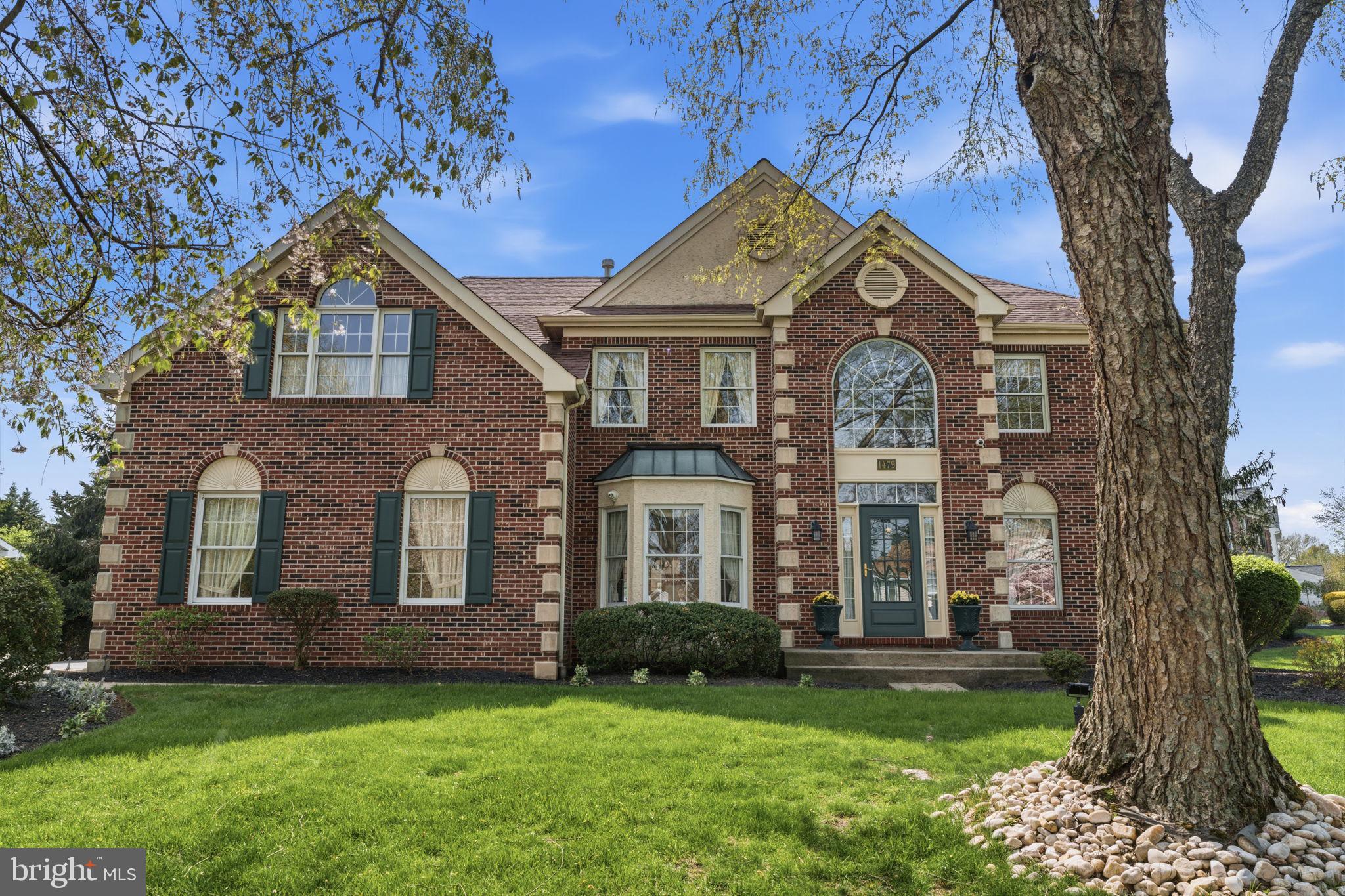 Welcome to this stunning 4-bedroom, 2.5-bath brick colonial where classic craftsmanship meets comfortable living across three beautifully finished levels.

From the moment you arrive, the striking all-brick exterior with quoined corners, arched windows, and lush landscaping sets the tone for the refined details found throughout. Step inside to a grand two-story foyer featuring an elegant curved staircase and rich oak railings.

The formal living room impresses with soaring cathedral ceilings, a brick fireplace, arched French doors, and intricate wall molding details. A dedicated first-floor office completes the main level perfectly.

The kitchen features white cabinetry, granite countertops, stainless steel appliances, and a center island, all set over warm hardwood floors. The real showstopper is the spectacular sunroom addition, a bright and airy vaulted retreat with painted shiplap walls, skylights, dual ceiling fans, and wraparound windows that flood the space with natural light and views of the yard. Whether you are enjoying your morning coffee or unwinding at the end of the day, this space will quickly become the heart of the home.

Upstairs, the expansive primary suite offers abundant natural light and generous space, accompanied by three additional well-sized bedrooms. The finished lower level adds incredible bonus space with a large open recreation area, perfect for entertaining, hobbies, or a home gym.

Located in the desirable Fairfield at Farmview community, this home offers a rare blend of traditional character and everyday functionality. Truly a gem.