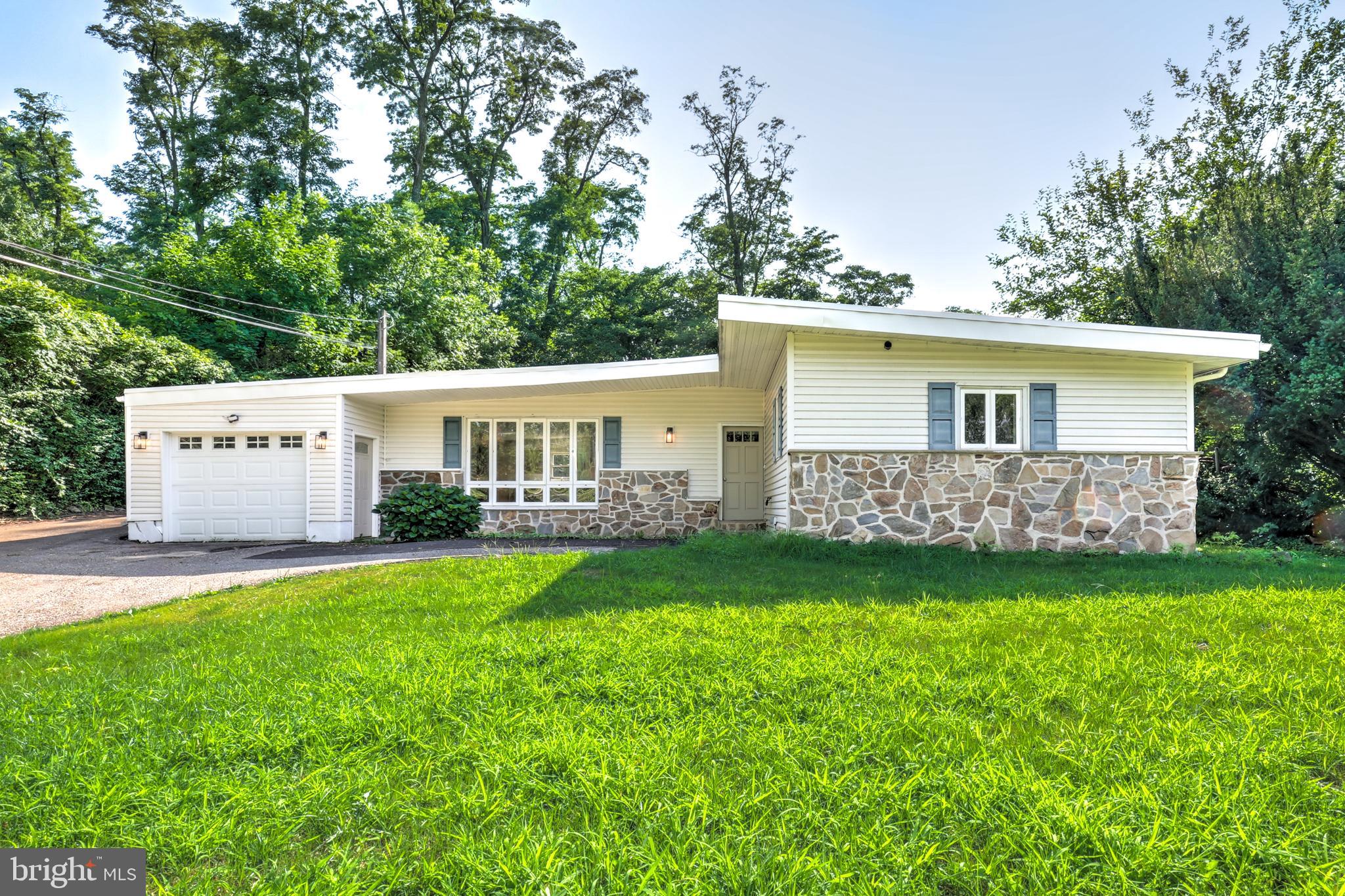 New well now installed.  Tucked away in a quiet residential pocket of West Chester, 904 S Chester Road is an exciting opportunity to own a truly special home that perfectly blends style, comfort, and location! This gorgeous, completely renovated 4 bedroom, 2 full bathroom  ranch-style mid-century home with attached garage is filled with eye-catching design! A striking exterior features updated siding, classic stone accents, and an iconic sloped midcentury roofline. Set on a nice, usable lot, the home also boasts a rebuilt deck that invites you to relax, entertain, and enjoy the outdoors. In addition, the oversized attached garage can fit two cars back to back, allowing for plenty of hobby or storage space. Inside, you’ll love the bright and airy open-concept living, dining, and kitchen space, where large windows flood the home with natural light and a beautifully restored double-sided stone fireplace creates a stunning focal point. The brand-new kitchen is truly the heart of the home, showcasing attractive wood-toned cabinetry, stainless steel appliances, and quartz countertops. A center island offers generous workspace and flexible dining options. An additional separate room off the main living areas provides the perfect spot for a playroom, home office, or versatile flex space. The bedroom wing features four comfortable bedrooms, including a beautiful primary suite with a private bathroom and walk-in shower. A second full bathroom serves the remaining bedrooms with a tiled tub/shower combination. Convenient main-floor laundry adds everyday ease, and the thoughtful renovation throughout makes this home completely move-in ready. A brand new rubber roof and new, efficient electric heat pump will keep you warm and dry this winter. With its standout midcentury style, functional layout, and desirable West Chester setting, this home is an absolute must-see!