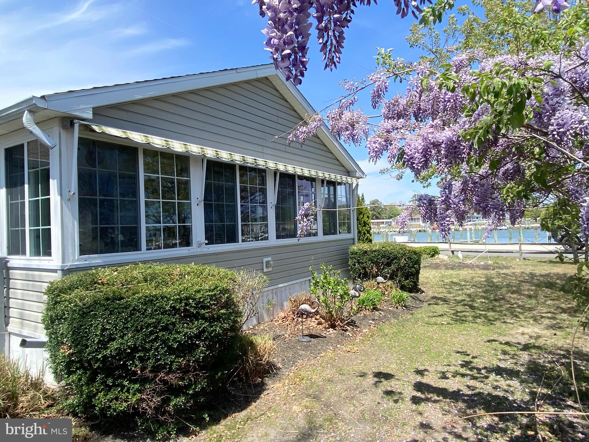 Dive into the ultimate waterfront lifestyle with this stunning home in the desirable Pot-Nets-Bayside community! Enjoy direct access to the Indian River Bay, perfect for boating adventures and serene days by the water. This spacious lot offers breathtaking marina views, setting the stage for a life filled with excitement and relaxation. 

Inside, you'll find a fabulous 3-season porch with vaulted ceilings, ideal for unwinding after a day on the water. This 1824 sq ft home features 3 bedrooms and 2 baths, with an open concept living area designed for entertaining. The large kitchen boasts ample counter space and a breakfast bar that any chef will love. 

The large heated and cooled sunroom provides stunning water views and a cozy brick fireplace, perfect for game nights or curling up with a book. Spacious bedrooms with plush carpeting ensure your guests feel at home, while the luxurious owner's suite features a step-up garden tub and shower. 

With a double garage for all your cars and beach gear, you’re set for unforgettable memories in Bayside! Enjoy numerous amenities like Paradise Grill, playgrounds, private beaches, and an extensive network of golf car paths. Don’t miss out on this incredible opportunity—call our sales office today!

Lot rent reflect the 2026 monthly fee