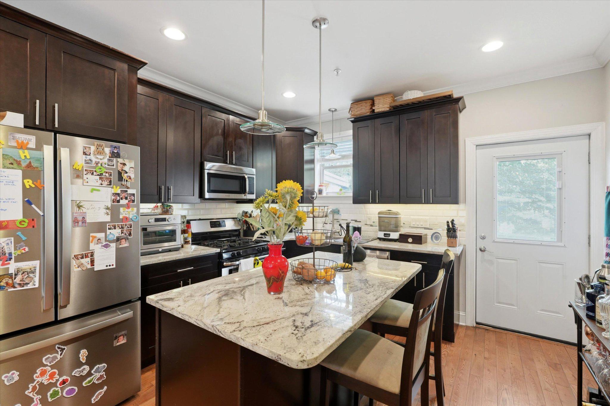 Welcome to 2207 E Oakdale Street — a meticulously maintained, three-story brick rowhome that delivers the space, finishes, and flex-living options rarely found at this price point. Located in the highly sought after Fishtown Neighborhood (Hackett Catchment), this home spans four finished levels including a fully finished basement, this home offers exceptional versatility for today's buyers.
The main level opens into a bright, open-concept living and dining area anchored by warm hardwood floors, recessed lighting, and crown molding throughout. The layout flows seamlessly toward a truly standout kitchen featuring rich espresso cabinetry, granite countertops, a large center island with seating, subway tile backsplash, stainless steel appliances, and pendant lighting — a setup that functions as the natural hub of the home. A rear door off the kitchen leads directly to the private backyard patio.
The fully fenced backyard is a quiet retreat, complete with a poured concrete patio, mature shade trees, privacy fencing with decorative planter accents, and a dedicated area for grilling. 
Upstairs, the second floor features a generously sized secondary bedroom, an additional bedroom or home office with great natural light, a full hallway bath, and a convenient second-floor laundry closet with a stacked washer/dryer — no hauling laundry up and down stairs. The third floor is dedicated entirely to the primary suite, which impresses with a tray ceiling, crown molding, recessed lighting, and dual windows bringing in natural light. The ensuite bath offers a double vanity with dark granite, an oversized tiled glass-enclosed shower, and tile flooring.
The bonus? A tucked-away wet bar/kitchenette nook with cabinetry and granite on the upper stair landing — a perfect setup for a coffee bar, home bar, or entertainment station. Just steps away, access the private rooftop deck with sweeping views of the Philadelphia skyline!
The finished basement adds a full additional living level, with tile floors, recessed lighting, a full bath — ideal as a media room, playroom, gym, or guest suite.
You will have no problem falling in love with the location! Just minutes away from your favorite Fishtown bars and restaurants such as Picnic, Emilia, Bastia, and more! Easy access to major highways (I-95) and public transit. 
This home checks every box, make sure to book your showing today!