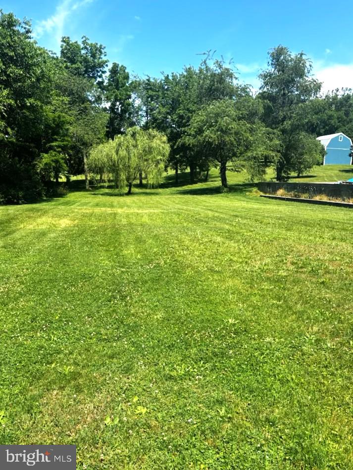 Beautiful and Buildable! Residential/Commercial on 1.38 acres.  Electric is currently being provided by piggy backing onto nearby property.   Pole is in for electric to be run to buildings.   Buyer can either hook up to public sewer (will need a pumping station) or put in a private septic.  Buyer will need to hook up to public water.  Property includes Pavillion, Shed and Red Pole Building.