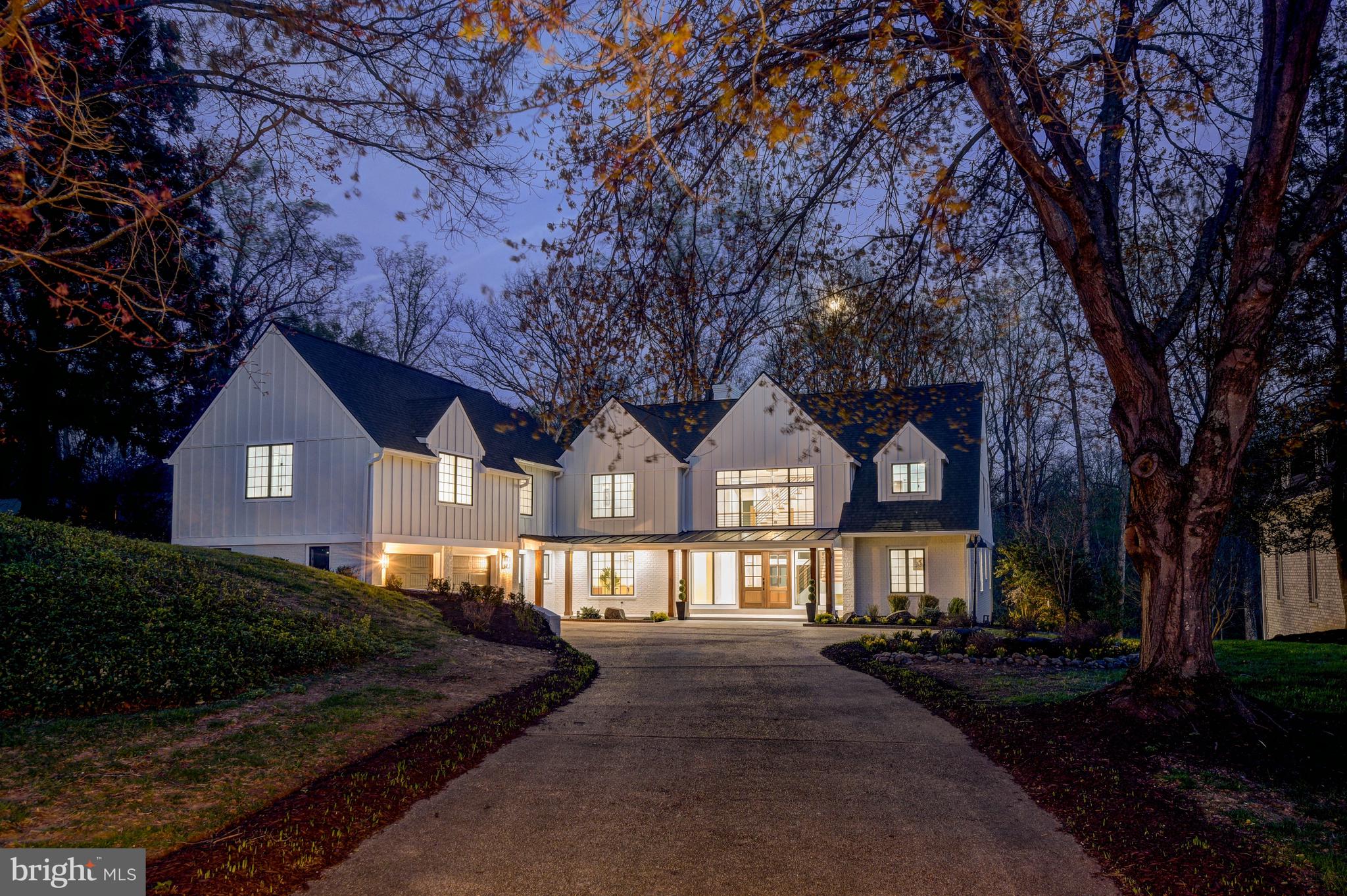 Located in coveted Bradley Hills Grove, 7126 Darby Road is a rare offering consisting of a primary front lot and a continuous parcel behind. The rear of the combined nearly 1-acre property delivers exceptional privacy, phenomenal views, and ample space for a swimming pool and more. From its lower edge, the sights and sounds of the neighboring creek can be enjoyed. Itself extraordinary, the home has just undergone a remarkable transformation and expansion. Awaiting the new owner is more than 7300 square feet of impeccable living space apportioned over four fabulous levels. With 8 bedrooms, 7 full, and 2 half bathrooms –inclusive of the dazzling, full 1BR/1BA apartment above the garage— this residence offers an unparalleled lifestyle and is perfectly suited to large scale entertaining as well as multigenerational living. Oversized windows and walls of glass bring the outdoors and sunshine in where satiny hardwood floors, a fresh consistent color palette, floor-to-ceiling fireplace surrounds, vertical slat wall accents, and a curated tile selection set a modern, uplifting tone. The open main level stuns with its immaculate two-story foyer and dramatic staircase, elegant dining room with statement lighting, sunken living and family rooms with sliding and multi-fold glass doors, center island chef’s kitchen with a large walk-in pantry, breakfast area with a coffee lounge, private corner office, bedroom with ensuite bath, two powder rooms, and a mudroom. Gracing the second level is a spacious primary suite with breathtaking views through the wall of windows, a fireplace, a gorgeous bathroom with a freestanding slipper tub, large glass shower, and a double vanity, and 2 walk-in closets. Completing this level are two additional spacious bedrooms each with beautiful ensuite bathrooms, a laundry room, and access to the full guest apartment and back staircase. The bright uppermost level provides more stunning views, a large loft sitting room, two spacious bedrooms, and a full bathroom. Downstairs, the walk-out lower level offers an expansive recreation room with glass door passage to a covered terrace, the eighth bedroom, the seventh bathroom, a large exercise room and vast storage space. Wonderful exterior features include a full width covered portico and mahogany double entry doors, an expansive flagstone terrace across the rear, an attached 2-car garage and large motor court, and lovely landscaping. Just around the bend from the Burning Tree Club, in the Burning Tree/Pyle/Whitman school district, and convenient to downtown Bethesda, Washington DC, and major travel routes, this location is superb.