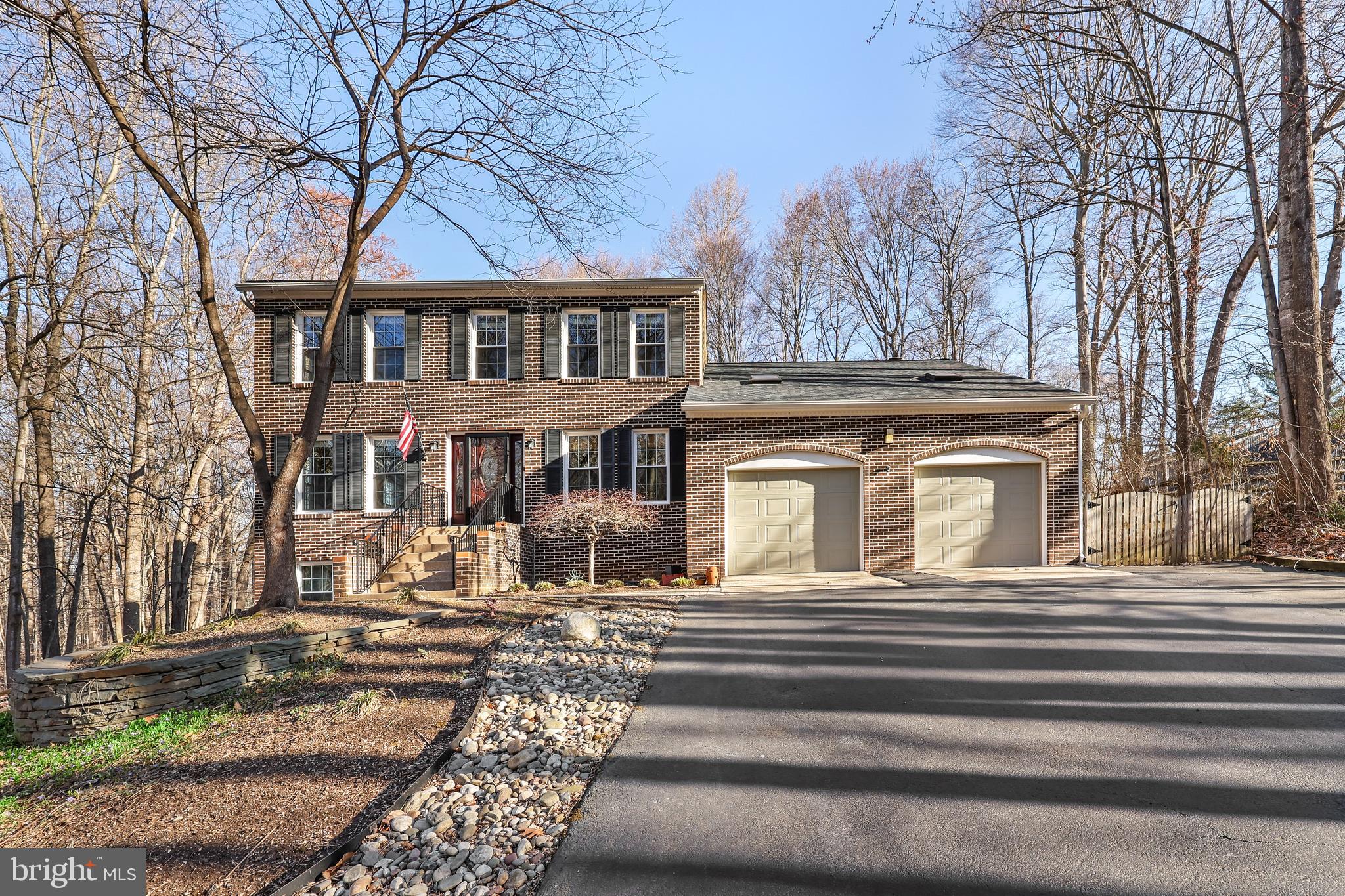 Welcome to 11709 Howitzer Ln, a stunning 5-bedroom, 3.5-bathroom home nestled on over 1 ACRE of picturesque land! As you enter the inviting foyer, you’ll immediately be captivated by the elegant hardwood floors that flow seamlessly through the upper two levels of the home. To your right, you’ll find a cozy office/study, while to your left, the spacious formal living room boasts crown molding and connects to the formal dining area featuring a bay window that overlooks the serene backyard.

The generous eat-in kitchen is a chef’s dream, complete with sleek granite countertops, stainless steel appliances, a built-in desk, and an abundance of cabinet space. Just off the kitchen, the bright and airy family room offers a wood stove, a skylight for natural light, and a sliding door that opens to your private Trex deck, perfect for relaxing or entertaining.

Upstairs, the expansive primary bedroom suite features two closets and a private bath, offering a peaceful retreat. Three additional bedrooms share a well-appointed hall bathroom. The finished walk-out basement is a true bonus, with a spacious rec room, a full bathroom, the 5th bedroom with a walk-in closet, and a versatile bonus room ideal for a media room, exercise space, or even a 6th (NTC) bedroom.

Step outside into the beautifully landscaped backyard, where mature trees surround the property, providing ultimate privacy on this rare 1-acre lot in Woodbridge. You’ll enjoy a tranquil natural setting while being conveniently close to shops, restaurants, major roads, and public transportation.

Residents of the Cannon Bluff neighborhood also have access to a 12+ acre park with Occoquan River access, perfect for boating and fishing. Recent upgrades include a new hot water heater (2023), HVAC units (2013 & 2018), chimney insert (2019), well pump (2017), fuse box (2017), roof (2016), shed roof (2016), and all-new windows (2016).