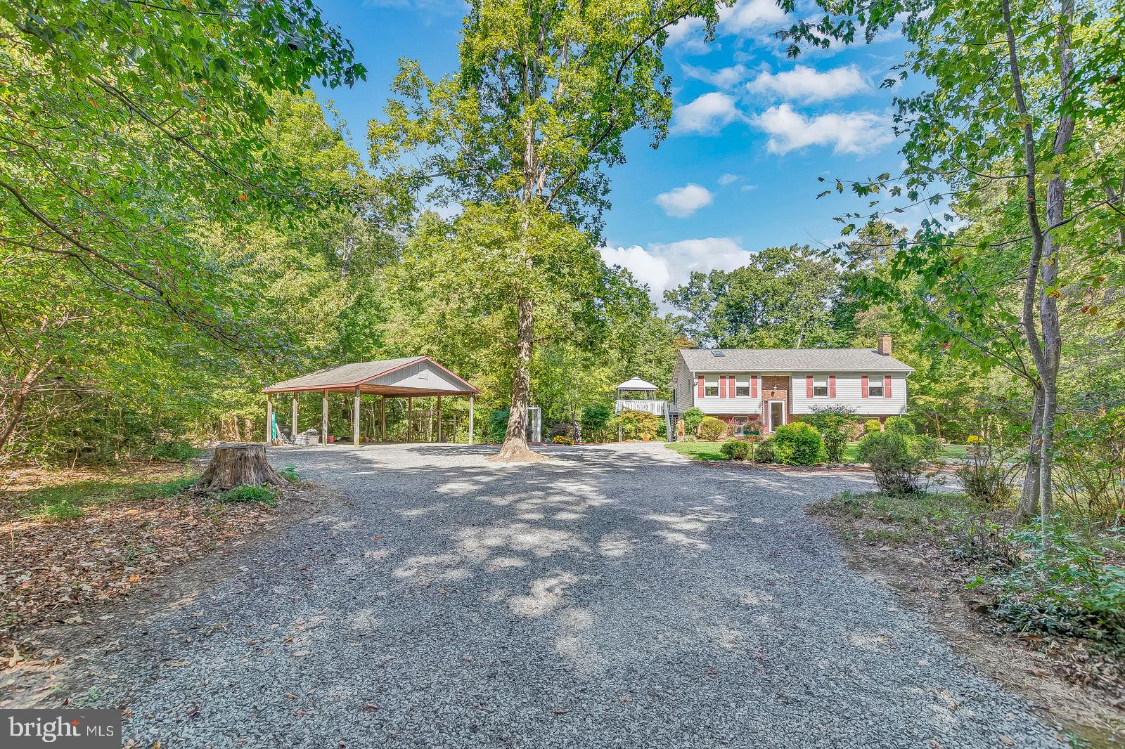 Exceptional Privacy! This meticulously maintained home boast 4 bedrooms, 3 full bathrooms, a potential 5th bedroom/workout room, rec room w/ wet bar that could be used as a 1 bedroom apartment, a huge 20x30 Carport w/ storage above, and best of all a WONDERFUL Private Lot! Recent upgrades include: Kitchen Renovation w/ Fresh Paint, Granite Countertops, New Cabinet Hardware, and Upgraded Stainless Appliances, Hall Bath Renovation w/ Fresh Paint, New Tub/Shower, New Vanity, and New Toilet, New Carpet in the sunroom, basement and all bedrooms! New Architectural Roof/Skylights in May 2019, Upgraded Amana HVAC system w/ Propane Back-up in 2012, Kenmore Stainless Appliances w/ a Gas Stove in 2015, Freshly Painted 20x20 Deck, 4 Season Sunroom, 8 x 12 Shed, and a Cast Iron Woodstove. The finished basement area is set up as a semi-private apartment area and could be used to create rental income or use the kitchenette as a bar area for your rec room! This home is definitely worth a look!
