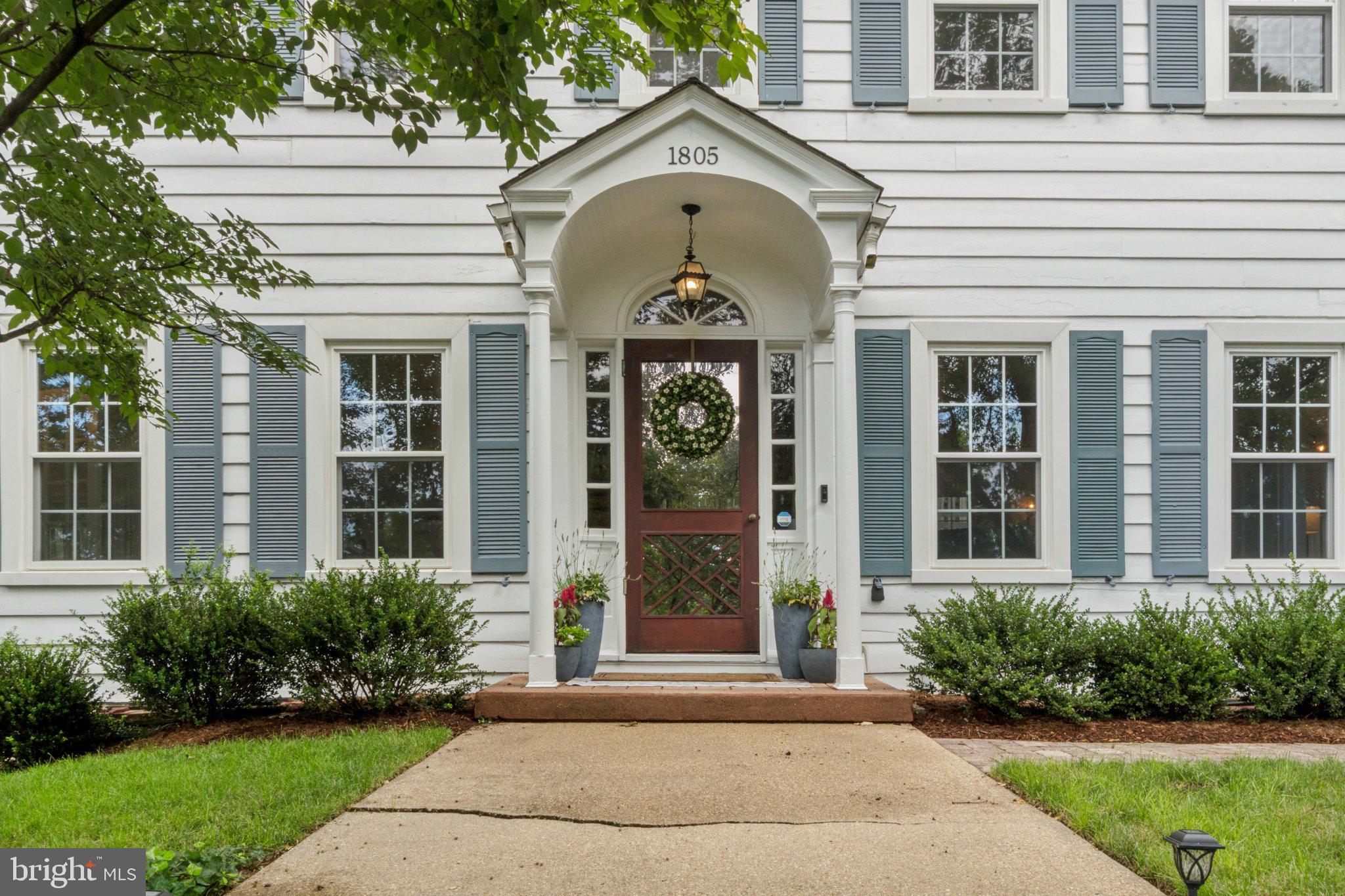Discounted- $371k below assessed value! Rare double-lot—0.59 acre / 25,700 SF—in sought-after 22202! Classic 1932 Sears Colonial set back from the street sits on a combined .59 acre lot (two lots included, 25,700+ SF). The expansive 5 bedroom, 3 full and 2 half bathroom stately center-hall colonial features a finished attic and rec-level, and is not to be missed. An elegant staircase leads you to the front door and into a welcoming foyer, hardwood floors throughout the main and upper levels shine in natural light from the abundant and oversized windows on all sides. The main-level legal bedroom suite with its own full bathroom and private entrance is ideal for live-in support such as aging in place or guests, and exits onto a second stone patio. Very generous proportioned rooms in this home, starting with the formal dining room and then enter the first living room through classic French doors. From the living room you can either enter into the park-like backyard or the open-concept kitchen, both of which are spacious for easy every-day life and entertaining. Kitchen boasts abundant white cabinetry, stainless steel appliances, granite countertops, a main-level half bathroom, and a second door that leads to the rear stone patio and deck. Upper level features three spacious bedrooms, two full bathrooms, stairs for the attic access, and an incredible owners suite. Owners suite is grand, boasting large windows, plenty of space for a king-sized bed and an additional sitting area, including three separate closets, one of which is walk-in, as well as an en-suite bathroom. Second and third bedrooms feature abundant closet space, loads of natural light, and share a hall bathroom with a large vanity. Upstairs in the loft, the finished attic includes a large bedroom and dedicated office with built-ins—and still leaves unfinished space for future expansion. Lower level has a large rec room, wet-bar, laundry/utility room, workshop, and an oversized two-car garage. Beautiful backyard features a large deck with seating, two stone patios, mature landscaping, and abundant grass. Supreme location—zero stoplights to Washington D.C.; walkable to the bus stop/metro and schools; and close to shopping, dining, and grocery stores. Easy access to the Pentagon, Amazon’s new National Landing HQ2 Headquarters, Virginia Tech Innovation Campus, and so, so much more! Live comfortably now, expand later, or explore redevelopment potential of the two deeded lots!