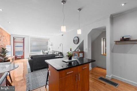 Exceptional INCOME-PRODUCING multi-family opportunity in the heart of historic OLD CITY. This BEAUTIFULLY RESTORED FOUR-STORY DUPLEX features two spacious residences under one roof and generates over $80,000 in annual rental income, making it an outstanding investment or future owner-occupant opportunity. Rich in historic character, the property showcases exposed brick walls, wide-plank hardwood floors, restored original details, decorative fireplaces, custom tile work, soaring 11-foot ceilings on the second floor, and updated kitchens and baths throughout. The first-floor bi-level residence offers approximately 2,000 square feet with a spacious open living area, custom kitchen with granite countertops and stainless steel appliances, one bedroom and full bath on the main level, a fully finished lower level with additional flex space ideal for a bedroom, office, gym or recreation room, laundry, abundant storage, and a private rear patio. The upper residence spans the second through fourth floors and features an OPEN LOFT-STYLE LAYOUT with hardwood floors, wood plank ceilings, a large eat-in kitchen, two bedrooms plus a flexible loft space, one full and a half bath, in-unit laundry, central air, generous closet space, and it’s own private fenced patio. Located in the heart of Old City. This location offers easy access to I-95, I-676, Route 76, Center City, Penn's Landing, Race Street Pier, Spruce Street Harbor Park, Jefferson, Cooper, and Pennsylvania Hospitals, acclaimed restaurants, boutiques, galleries, coffee shops, neighborhood markets, and Philadelphia's most iconic historic landmarks. A rare opportunity to own a TURNKEY INVESTMENT property in one of the city's most desirable and consistently high-demand neighborhoods.