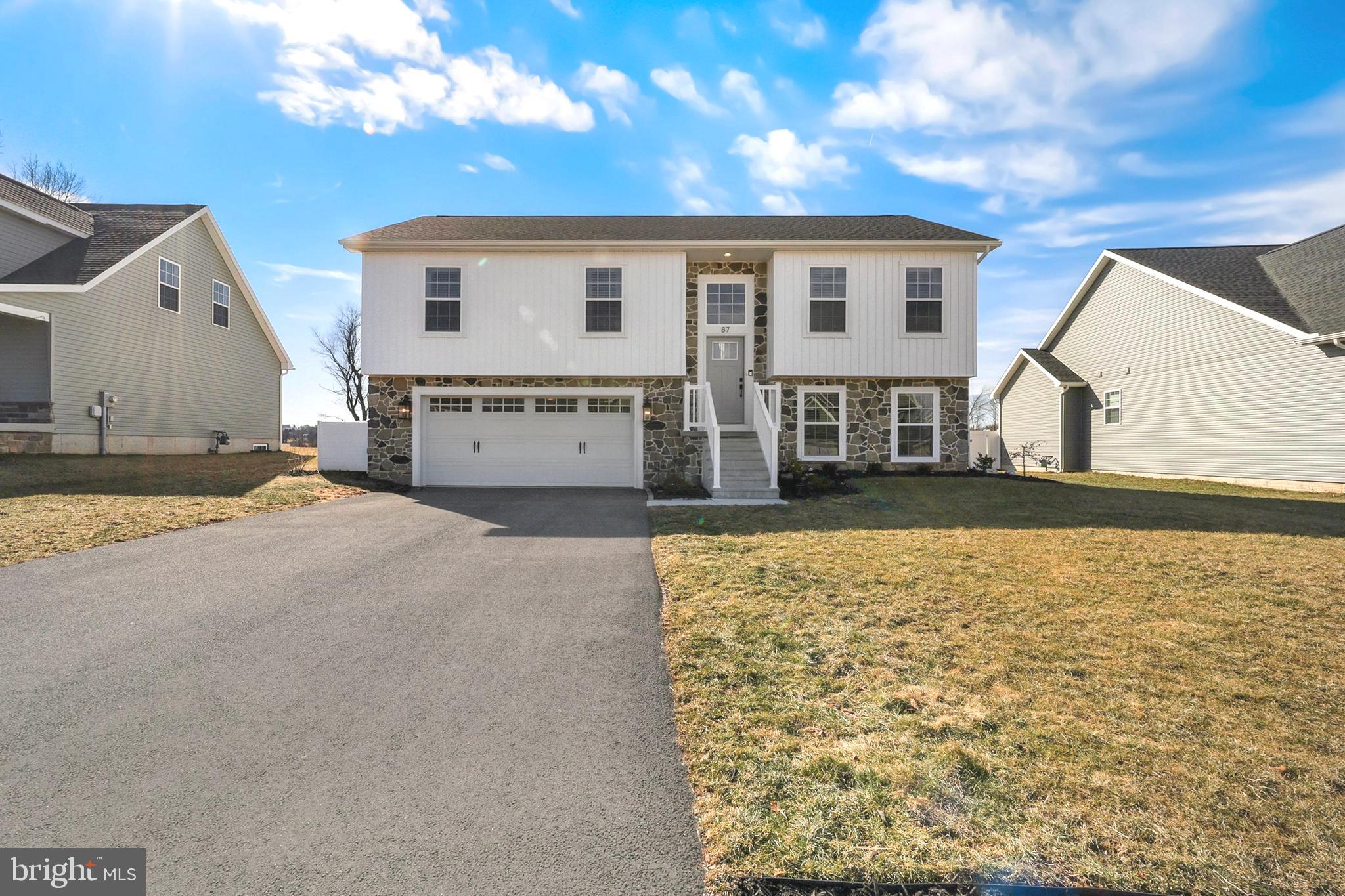 Better than brand new- why wait to build when this stunner is available?! This newly built 3 bed, 2 bath split level home is move-in ready and just waiting for your personal touch. Upon entering the home you’ll be greeted with beautiful LVP flooring in the foyer leading upstairs or downstairs to the fully finished basement. Head up the steps to find an open concept living, kitchen, and dining area- plenty of space for entertaining and every day living. The eat-in kitchen includes beautiful white shaker-style cabinets, quartz countertops, white-washed brick backsplash, stainless steel appliances, an oversized kitchen island for additional seating and counterspace, and custom exposed wood beams accompanying the high cathedral ceilings. Find the cozy living room with an abundance of natural lighting directly off of the eat-in kitchen. Just down the hall from the kitchen you will find the primary bedroom with its own private bath, two additional bedrooms and an additional hall bath. The basement is fully finished with tons of natural lighting perfect for additional living space, a rec room, exercise area, or playroom. What will you make it? Additional features include all sheet metal duct work for easy cleaning (not standard), a two-car garage with access to the basement, oak railings, marble vanity tops in the bathrooms, a separate laundry/storage room, timed exterior lights, and much, much more! Come see this beauty for yourself!