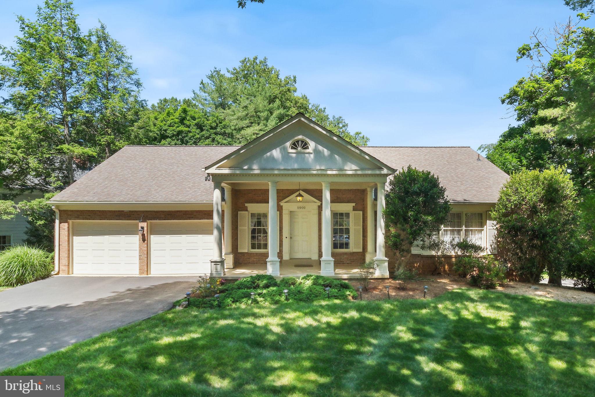 Welcome to 11900 Canfield Road, located in the well-established and sought-after Falls Reach community of Potomac. This expansive rancher offers four bedrooms, three full bathrooms, two powder rooms, and 3,842 total square feet across two finished levels. Thoughtfully maintained and updated by the original owners, the home has important updates including a newer roof (10–12 years ago), all interior and exterior pipes replaced with PVC, a hot water heater replaced (2016), HVAC coil replaced (2024), remodeled bathrooms (all three full baths), garage floor recently resurfaced (2026), and front entry recently painted (2026). The 0.28-acre lot provides abundant  level green space in the backyard. The newer Trex deck offers access from the living room and breakfast area — perfect for relaxing, entertaining, and outdoor dining.
A flagstone walkway and portico entry with classic columns welcome you to the home. Inside, oversized rooms, large windows, hardwood floors throughout the main level, vinyl hardwood-style flooring throughout the lower level, and abundant natural light set the tone. An open foyer, finished with a ceramic tile floor, offers convenient access to the powder room and attached 2-car garage. The foyer flows seamlessly into the living room, where sliding glass doors provide unobstructed views of the backyard and open to the rear deck. The adjacent formal dining room includes wall sconces, crown molding, and a wall of windows. The eat-in kitchen, accessible from both the foyer and dining room, features newer quartz countertops, newer stainless steel appliances, dark wood cabinetry with contemporary hardware, a range with convection option, a built-in microwave, and a peninsula breakfast bar. A large breakfast area is framed by sliding glass doors to the deck and includes a brick accent wall with a cozy gas fireplace. The opposite wing of the main level provides three bedrooms and two full bathrooms. The primary suite offers two wide closets and an updated bathroom with a double vanity, a glass-door shower, and travertine-style tile finishes. All full bathrooms have been updated with modern vanities, glass-door showers, smart toilets, and stylish tile and hardware. Two additional bedrooms, multiple linen closets, and a laundry room with a front-loading washer/dryer, cabinet storage, and utility sink complete the main level. The finished lower level provides additional flexible living space with 1.5 bathrooms, a large rec room with a bar area, a gas fireplace, and sliding glass doors to the backyard. Separated by a wide archway, the adjacent room is well suited for use as a media room, game room, or home gym. A craft space (or second mudroom) includes a back door providing a private entrance, along with access to the lower level bedroom and updated ensuite full bathroom, creating potential for a guest suite or multi-generational living. A large utility room with additional storage completes the lower level. Ideally located with easy access to shopping, dining, entertainment, and major commuter routes. Close to parks, recreation, and nationally rated golf courses. Served by top-rated Montgomery County schools. Don’t miss this rare opportunity to own in one of the DC area’s most desirable communities!