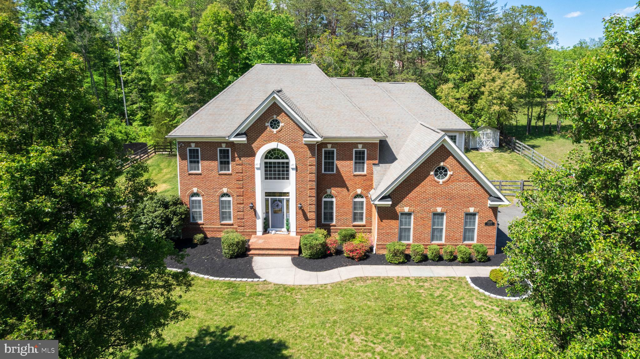 OPEN SUN JUNE 7th 1pm - 4pm! Marshall / Benton / Colgan Pyramid. Picture Perfect 6,539 finished sq ft | 5 BR | 4.5 BA custom-built brick and HardiePlank Colonial w/ massive 3-car garage. Situated on a FLAT one-acre lot down a dead end, private enclave with no HOA on public water / public sewer, this tastefully-designed space blends luxury with modern comfort of indoor/outdoor living.  The main level opens into a 2-story Foyer and features an open floor plan highlighted by a truly exemplary Chef-inspired Kitchen (2021 renovation) leading into a dramatic, 2-story Great Room with gas fireplace, custom coffered ceiling and direct access to the park-like outdoor hardscape and fully-fenced yard.  Speaking of yard, the backyard backs to open pasture green space and the property includes added land across the private road along with a massive front yard and grand driveway. 

Rich hardwoods blend each space on the main level, which also includes a dedicated home office with 8-foot French Doors, a separate Dining Room, and open Living Room flanked by windows w/ plantation shutters. Design touches like wainscoting wall panels, columns, and expansive crown moulding integrate with the high-end interior paint and are showcased w/ added depth by the natural light on walls of windows surrounding each room.

Focal points of the Kitchen start with an abundance of Charleston-styled cabinets that wrap through a Butler's Pantry to the Dining Room. In addition to the centerpiece island, the Kitchen comes complete with a showpiece Range Hood, leathered granite countertops, extensive marble subway tile backsplashes, designer lighting, double ovens, and a luxury WOLF gas cooktop situated under a pot filler. Try not to get lost in the walk-in Pantry for plentiful dry storage and enjoy coffee from the adjacent Breakfast Room.

The Upper Level is designed with thoughtful functionality, starting with a Primary bedroom w/ tray ceiling that includes a 3-sided gas fireplace bisecting the sleeping area from the ensuite Sitting Room. Closet Space? Try 3 walk-ins, including a dedicated closet "room" that is larger than most bedrooms. The primary bath gives Four Seasons vibes  starting w/ the heated tile floors and featuring a massive seamless glass walk-in shower w/ dual rain heads and stone soaking tub, Three additional bedrooms each have their own personality, including a bedroom with it's own ensuite bathroom fully-renovated in 2025 with a sleek barn door and finishes. Bedrooms 3 and 4 have plenty of space to spread out and share a full Jack-and-Jill bathroom. Modern touches even extend to the upstairs laundry room, which includes an upgraded sink and a dryer vent booster fan (2025 upgrade).

A versatile, walkout Lower-Level w/ separate entrance hosts the 5th bedroom with a walk-in closet next to the 4th full bathroom. The Rec Room includes a 3rd gas fireplace and wet bar with wine storage - while leading to the epicenter of at-home entertainment private Home Theater. The design brings the cinema to you with elegant mood lighting, surround sound, and eight theater chairs on a cascading raised platform complete with state-of-the-art projector and screen. Snacks? The built-in wet bar and refrigerator will cater to your guests.  How about storage? Enjoy access to one of the largest storage rooms you'll see in the area inside the house + a separate Storage Shed outside in the backyard that comes with its own snowblower for those winter storms.

Additional upgrades include a Central Vacuum system, replacing the 2 HVAC zones (approximately 3 years old), installing dual sump pumps with battery backup (approximately 3 years old), adding a whole-home filtration system, and installing a tankless water heater.

And just in time for Summer...a nicely-appointed outdoor Kitchen-area built into the patio can be customized for whatever propane grilling, meat smoking, or flat top Blackstone cooking you desire.