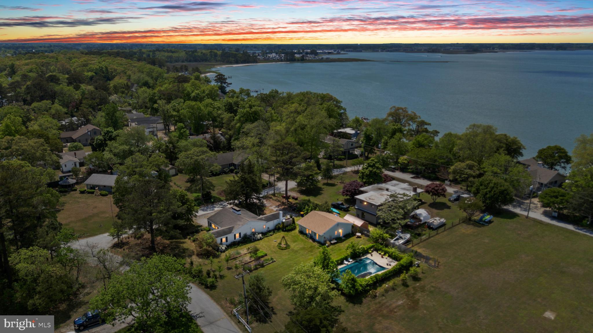 Just steps from the Indian River Bay and the VFW, this fully renovated 1950s beach cottage in Ocean View offers a rare blend of vintage charm, thoughtful modern upgrades, income potential, and future development opportunity with a second buildable lot. From the moment you arrive, the character of this home is evident, surrounded by lush landscaping, mature greenery, and a variety of fruit trees that create a peaceful, private coastal retreat.

The main house is filled with warmth and personality, featuring hardwood floors, exposed beams, and rich wood paneling that honor its original character, while key updates provide comfort and functionality. The inviting living space is anchored by a brick accented fireplace with a wood burning stove, perfect for cozy evenings year round. Renovated bathrooms, updated wiring throughout, beautiful tile flooring, ceiling fans in every bedroom, and central AC ensure the home lives as comfortably as it looks.

The eat in kitchen is both charming and functional, complete with a Viking range and ample space to gather. As an added bonus, you will even enjoy a slight bay peek through the kitchen window while doing dishes, a subtle reminder of just how close you are to the water.

Adding to the property’s versatility is the detached 2 car garage, which has been thoughtfully converted into a successful Airbnb suite known as the Surf Shack. This private guest space includes a bedroom, full bath, mini split system, and new roof, and has consistently generated $18,000 to $25,000 annually, making it ideal for supplemental income, guest accommodations, or a private retreat.

The outdoor setting is equally impressive. The 20 by 40 ft in ground pool is perfectly positioned on the second buildable lot, offering endless potential, whether you envision building an additional home, expanding outdoor living space, or simply enjoying the extra privacy and flexibility of owning nearly 3 tenths of an acre in this desirable location.

With close proximity to the Indian River Bay, local favorites, and just minutes to Bethany Beach, this property truly offers the best of coastal living, whether you are searching for a primary residence, vacation getaway, or investment opportunity.

Opportunities like this are few and far between. Do not miss your chance to own a unique piece of Delaware beach history with room to grow.