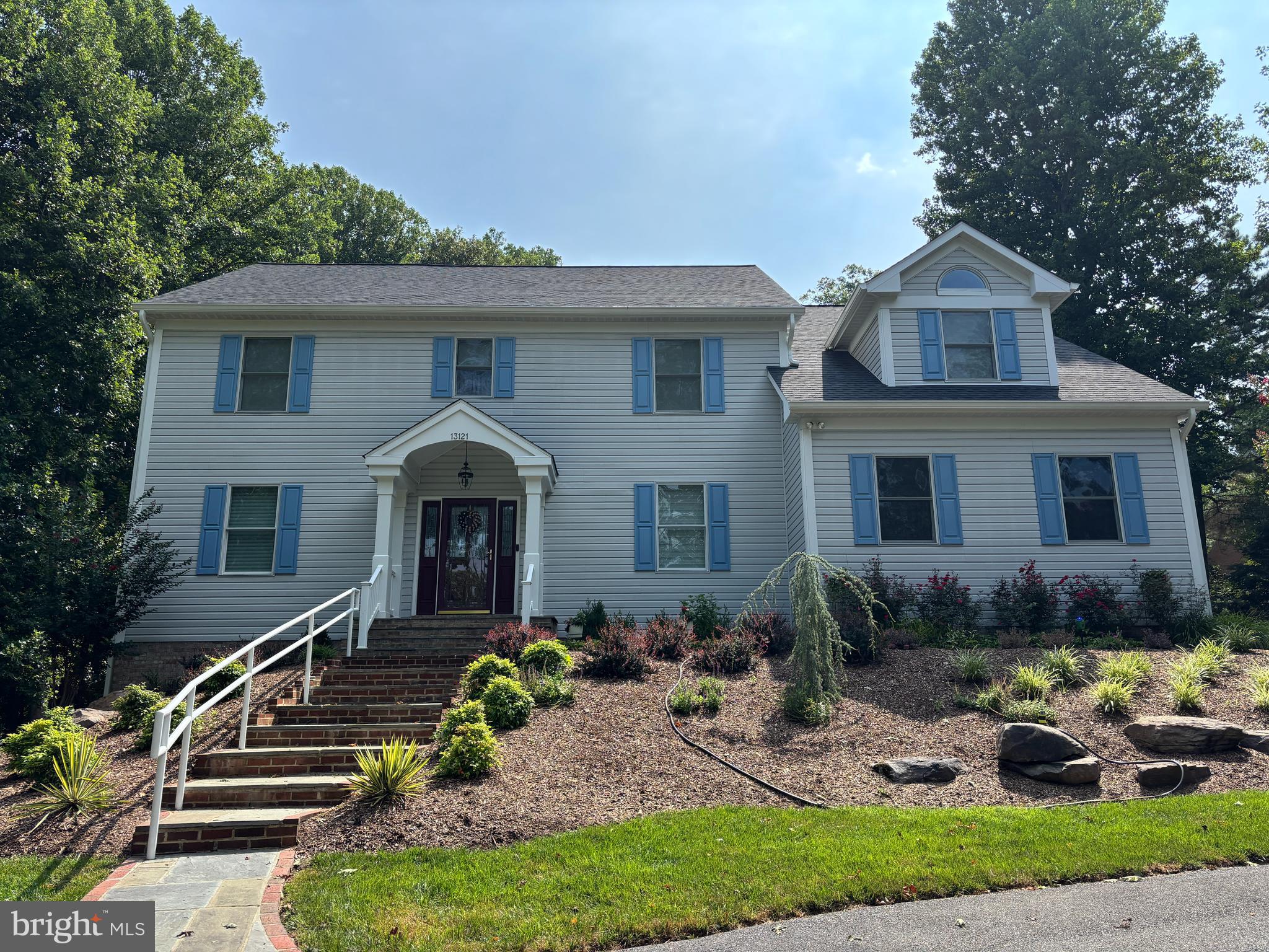 First time on the market! This exceptional custom home is a rare chance to own a private retreat in the coveted Wootton HS cluster after being updated and cared for lovingly by its original owner. Tucked away on a shared private driveway, this light-filled home sits on 2.75 acres backing to a wooded area and  stream, offering over 4,800 square feet of thoughtfully designed living space with 4BRs, 4BAs, and 1HB. The home underwent an extensive refresh (2020-2021), including refinished HW floors, updated flooring in the sunroom and lower level, designer lighting, and numerous additional enhancements. Architectural highlights include soaring 9-foot ceilings, dual-zone HVAC systems, propane gas cooking, and a striking custom stone fireplace. A gracious two-story foyer welcomes you, w/gleaming hardwood floors throughout the main level. Formal living and dining rooms are elegantly appointed with chair rail detailing, while French pocket doors lead from the Foyer into the family room and traditional pocket doors lead from the formal living room to a private home office. 
Bathed in natural light from six dramatic skylights, the family room showcases the home's impressive custom stone fireplace, creating a warm and inviting gathering space. Just beyond, the gourmet kitchen is designed for both everyday living and effortless entertaining. A generous center island with space for counter-height seating, four-burner gas cooktop, double wall ovens, wet bar, pantry, updated stainless steel appliances, and wall of windows overlooking the backyard combine beauty with functionality.
The adjoining four-season sunroom serves as one of the home's most captivating spaces. Featuring luxury vinyl plank flooring, shiplap accent walls, and dedicated climate control for year-round comfort, it offers breathtaking views of the professionally landscaped grounds. Step outside to enjoy the maintenance-free Trex deck, spacious paver patio, centerpiece garden, electronic dog fence, storage shed (conveys), and the tranquil stream that borders the rear woodland area of the property, creating an idyllic outdoor sanctuary.  

Completing the main level are an updated powder room with custom faux-finished walls, a functional mudroom, and an oversized side-load two-car garage that leads out to an extended parking area built alongside the circular drive to accommodate multiple vehicles.

Upstairs, four bedrooms and three full bathrooms continue the home's bright, airy ambiance. The luxurious primary suite offers cathedral ceilings, skylights, a walk-in closet with custom built-ins, and an additional full-wall closet. Renovated in 2020, the spa-inspired primary bath features dual vanities, a freestanding tub with garden views, and an elegant glass-enclosed custom tile shower.

The secondary bedrooms are equally impressive. The second bedroom includes a private ensuite bath, updated vanity, oversized walk-in closet, and an additional wall-length closet. The third bedroom features vaulted ceilings and two customized closets with built-ins, while the fourth bedroom is filled with natural light from two walls of windows. An updated hall bath with dual vanities, tile flooring, linen storage, and a tub/shower combination serves the remaining bedrooms. An upper-level laundry room with a washer and dryer (2021) and folding station adds everyday convenience. The renovated lower level offers flexibility for recreation and entertaining. LVP flooring, tri-tone lighting , custom shelving, and an open layout create the perfect setting for game nights  or casual gatherings. A full bathroom and under-stair storage further enhance the versatility of this level. All of this and easy access to River Rd.,  Bretton Woods Country Club, shopping and dining at Kentlands, Fallsgrove, and Potomac Village, nearby wineries, parks, and scenic walking trails. An exceptional home where timeless design, modern updates, and a natural setting come together to create a home unlike any other.
