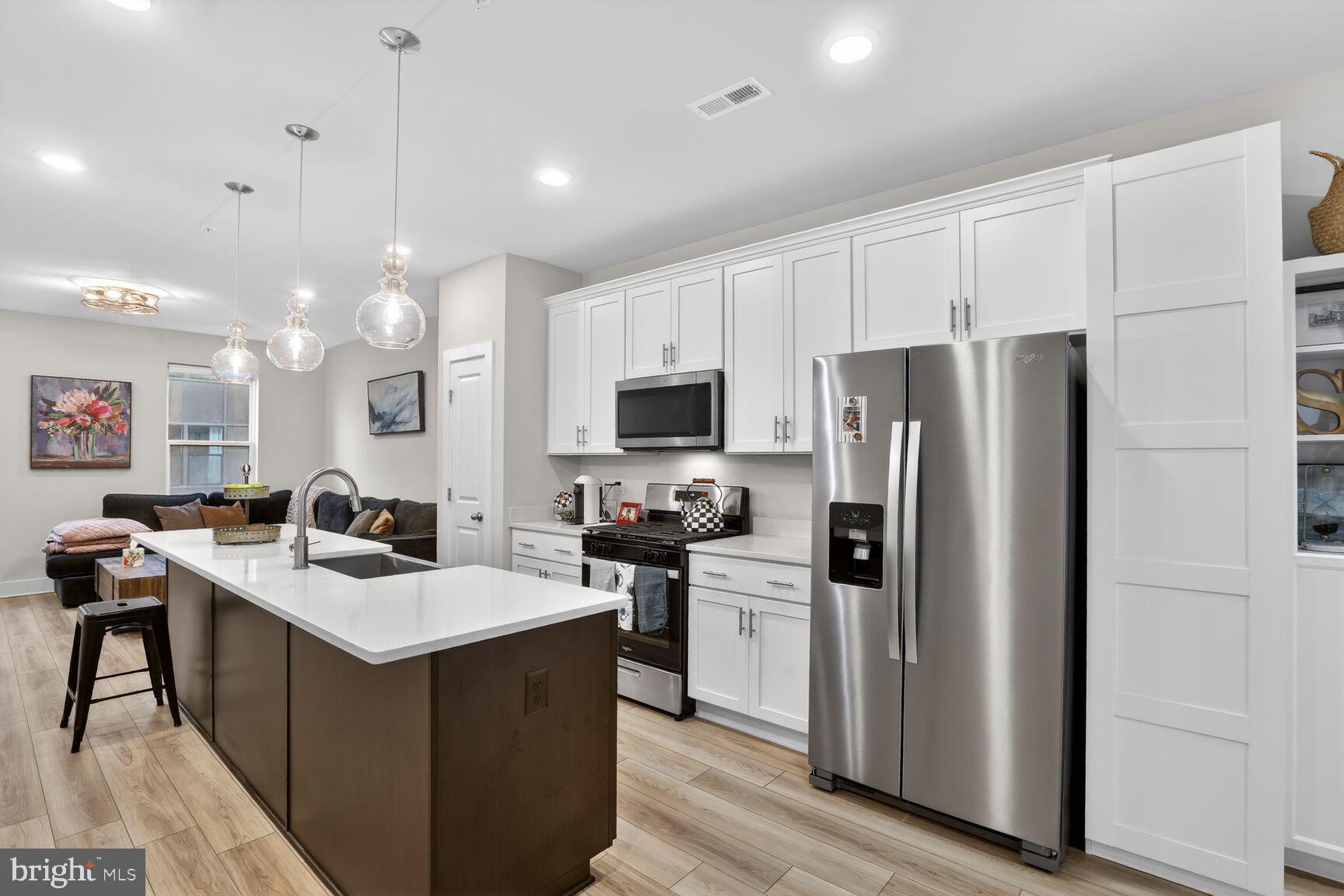Welcome to refined waterfront community living in the sought-after community of Locke Landing, located within the vibrant Baltimore Peninsula in Baltimore. Built in 2024 and extensively upgraded, this almost-new Bridgton model by DRB Homes offers a rare opportunity to own a move-in-ready luxury townhome just moments from the water.

Imagine stepping out your front door and embracing the waterfront lifestyle—morning walks along the harbor, evenings enjoying river breezes, and the energy of one of Baltimore’s most exciting waterfront communities right outside your doorstep.

Spanning four thoughtfully designed levels, this elegant residence features 4 bedrooms and 4.5 baths, blending modern design with exceptional comfort. Over $51,000 in upgrades have already been completed, and a valuable Baltimore property tax credit transfers to the new owner for the next eight years, adding long-term value. As an added bonus, the Seller is offering a $10,000 closing credit plus a $5,000 lender credit if Buyer uses the seller’s preferred lender.

The entry level offers a versatile bedroom or private office with a full bath—perfect for guests, remote work, or multigenerational living.

The main living level opens to a light-filled open floor plan designed for both entertaining and everyday living. At the heart of the home is a stunning chef’s kitchen featuring an oversized quartz island, premium appliances, and sleek modern finishes. The dining area is enhanced with custom built-in bookshelves that convey with the home, adding warmth and character. Just beyond, a private rear deck provides the perfect setting for outdoor dining or relaxing.

On the third level, the spacious primary suite offers a peaceful retreat with generous walk-in closets and a beautifully finished spa-inspired bath featuring a double-sink vanity and frameless glass shower with dual showerheads. A secondary bedroom with its own en-suite bath and a conveniently located laundry area complete this level, providing thoughtful functionality for daily living.

The top level is a true highlight—designed for entertaining and enjoying the waterfront lifestyle. A recreation room with wet bar, an additional bedroom with en-suite bath, and a private rooftop terrace with views of the nearby Patapsco River create an exceptional indoor-outdoor living experience.

Additional upgrades include premium luxury vinyl plank flooring, elegant staircases with white risers, and a fully integrated smart home system, giving the home a polished and contemporary feel throughout.

Ideally located just minutes from the vibrant neighborhoods of Federal Hill and Locust Point, residents enjoy convenient access to waterfront parks, shopping, and dining—including everyday essentials at Harris Teeter and many of Baltimore’s most celebrated restaurants and attractions.

Sophisticated, stylish, and nearly new, this exceptional home offers the best of modern waterfront living in one of Baltimore’s most exciting new communities.