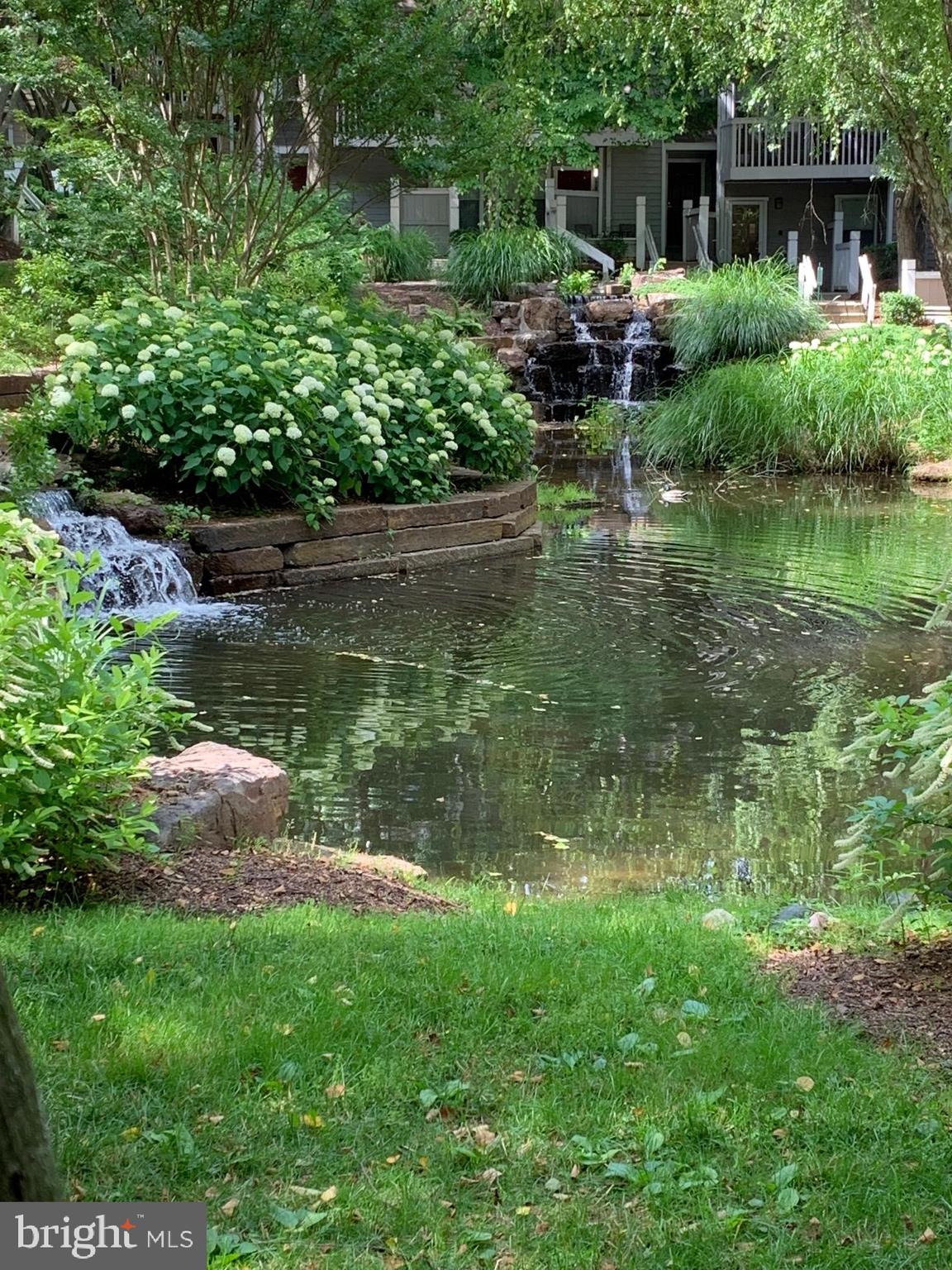 Beautiful one level 2 bedroom/2 bath condo. Enjoy one level open floor living, in this updated condo with stainless steel appliances, (brand new range and microwave), hardwood floors throughout, with chair and crown moldings, built ins, granite counters, living room with wood burning fireplace. Full size washer/dryer in unit; walk in closets, tennis courts, gym and pool (separate fee for pool). Enjoy a private sunny front porch for seating overlooking waterfall and gazebo. Minutes to Metro, Pike and Rose, I-270 and 495.