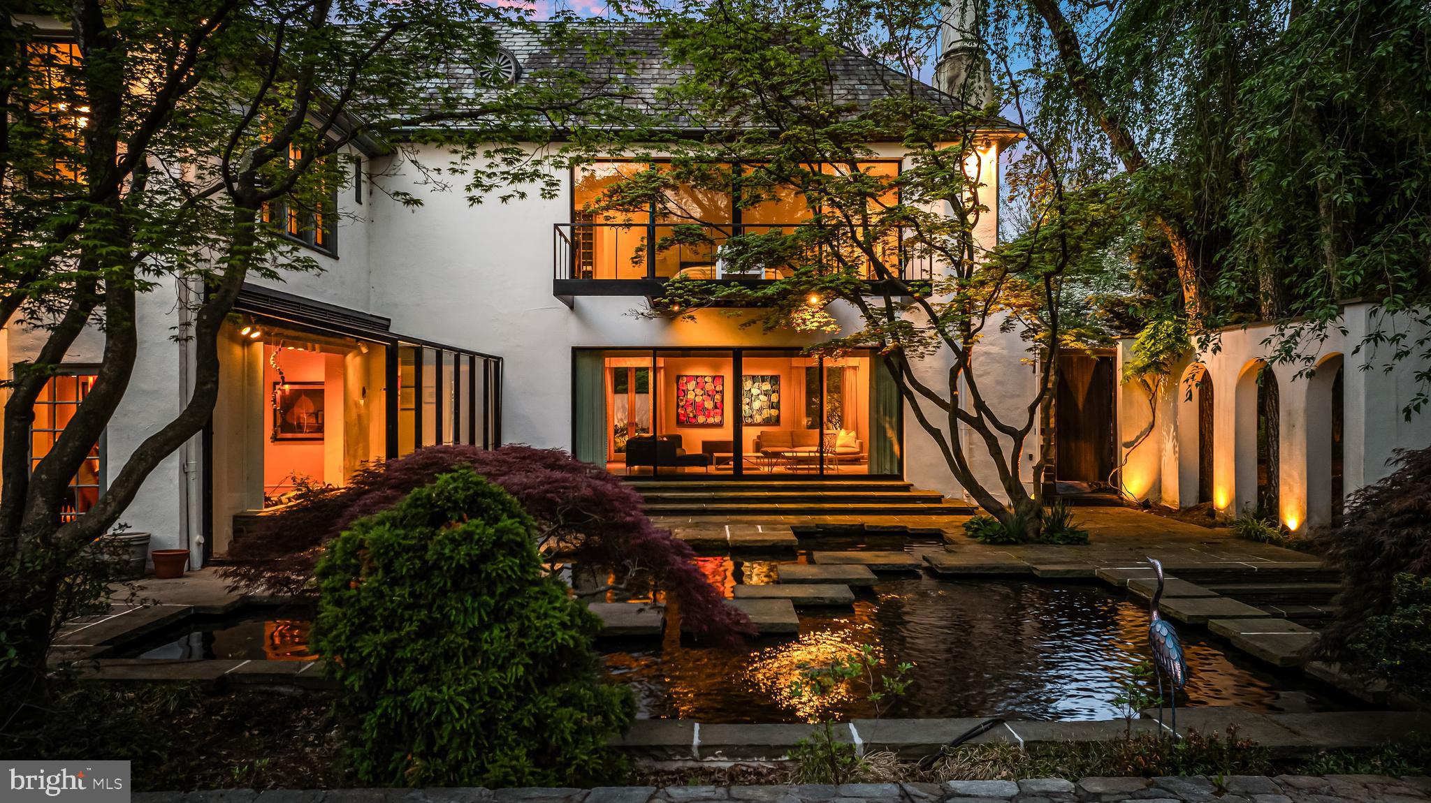 Nestled on one of Baltimore’s finest residential streets,  21 Blythewood Road once served as the residence of Howard Head, a visionary in the sports of tennis and skiing, who invented the oversized tennis racquet and laminated metal skis. Head meticulously redesigned the five-bedroom luxury home and grounds with wonderful living and recreational spaces. As if updating Head's vision, the current homeowners have brought the home into the 21st century with many improvements including new white oak hardwood flooring in many rooms, modern lighting throughout, closet systems and meticulous maintenance of its state of the art systems . Located on nearly two acres in the highly desirable Blythewood community, this English country style home welcomes guests into a garden courtyard accented by an antique lamppost. The beaded oak entry door opens into a classic vestibule and foyer. A wide cased portal leads into the adjoining living room featuring an oversized fireplace, concealed bar, built-ins, French doors to the front garden and a breathtaking window wall with sliding doors to the two-tier, 11,000 gallon Koi pond and bluestone patio. Steps from the foyer lead to the solarium with two walls of glass and greenhouse ceiling as well as a wide stone planter open to the adjacent dining room with a fireplace and doors to the patio. The tremendous, Trish Houck designed custom gourmet kitchen provides extensive cabinetry, quartz and granite counters, professional grade stainless appliances and an attached breakfast area, perfect to daydream over coffee through two full-length windows at the patio and pond. A hall leads to the chestnut library with built-in bookcases and cabinetry as well as floor length triple casement windows and a fireplace. A fully renovated powder room and an exquisite family room with vaulted, wood paneled ceiling, built-ins, wet bar and billiard area complete the main level. A large hall on the second floor flows to a seating area with a fireplace and banister overlook. A private hall provides entry to the primary bedroom suite where a window wall with sliding doors opens onto a large balcony overlooking the Koi pond, pool and extensive woodland gardens. Pocket doors lead into the attached dressing room with extensive custom fitted wardrobe cabinetry and a triple casement window and into the primary bath with heated porcelain tile floor, full-width cantilevered double vanity and glass-enclosed shower stall. Two additional, large en-suite bedrooms (one with fireplace and fully renovated bath) and a bedroom passage leads to bedrooms four and five as well as a hall bath. The third level provides a walk-in cedar closet and additional storage. A back foyer on the lower level leads to the attached three-car garage while a separate hall opens to the laundry room, climate-controlled wine room, exercise room and bath. In addition to the extraordinary back patio and Koi pond, extensive decking and patios lead to the picturesque pool complex with a hot tub, built-in bench seating, and a large custom built-in teak bar. The pool area overlooks the fabled tennis court, specifically designed below grade to ensure a natural barrier to wind. This competition quality tennis complex is one of the most beautiful private courts in the country and many tennis luminaries have played on this fabled surface . Terraced lawns accented by extensive stone garden walls lead to the wooded hillside garden area with floating curved steps, a man-made stream and waterfalls creating a fairytale setting. Designed throughout with state-of-the-art lighting and irrigation and stormwater management systems to maintain this lush venue and showcase it to the best advantage. Located on nearly two gorgeous and thoughtfully landscaped acres, this is a rare opportunity to acquire one of the most spectacular properties in Baltimore.